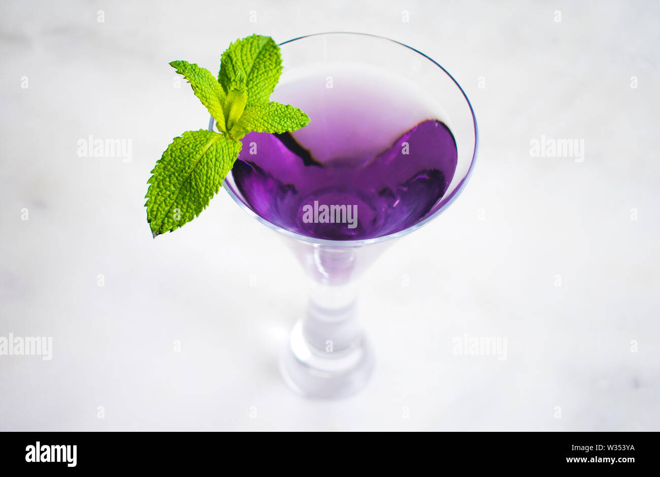 Purple Cocktail with Mint Garnish Stock Photo Alamy
