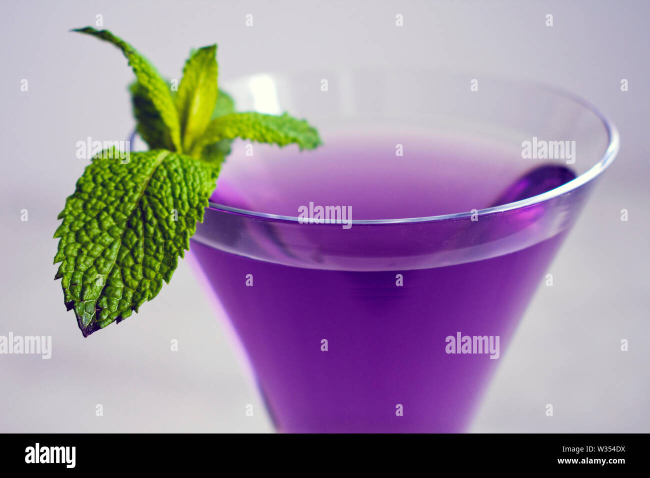 Purple Cocktail with Mint Garnish Stock Photo Alamy