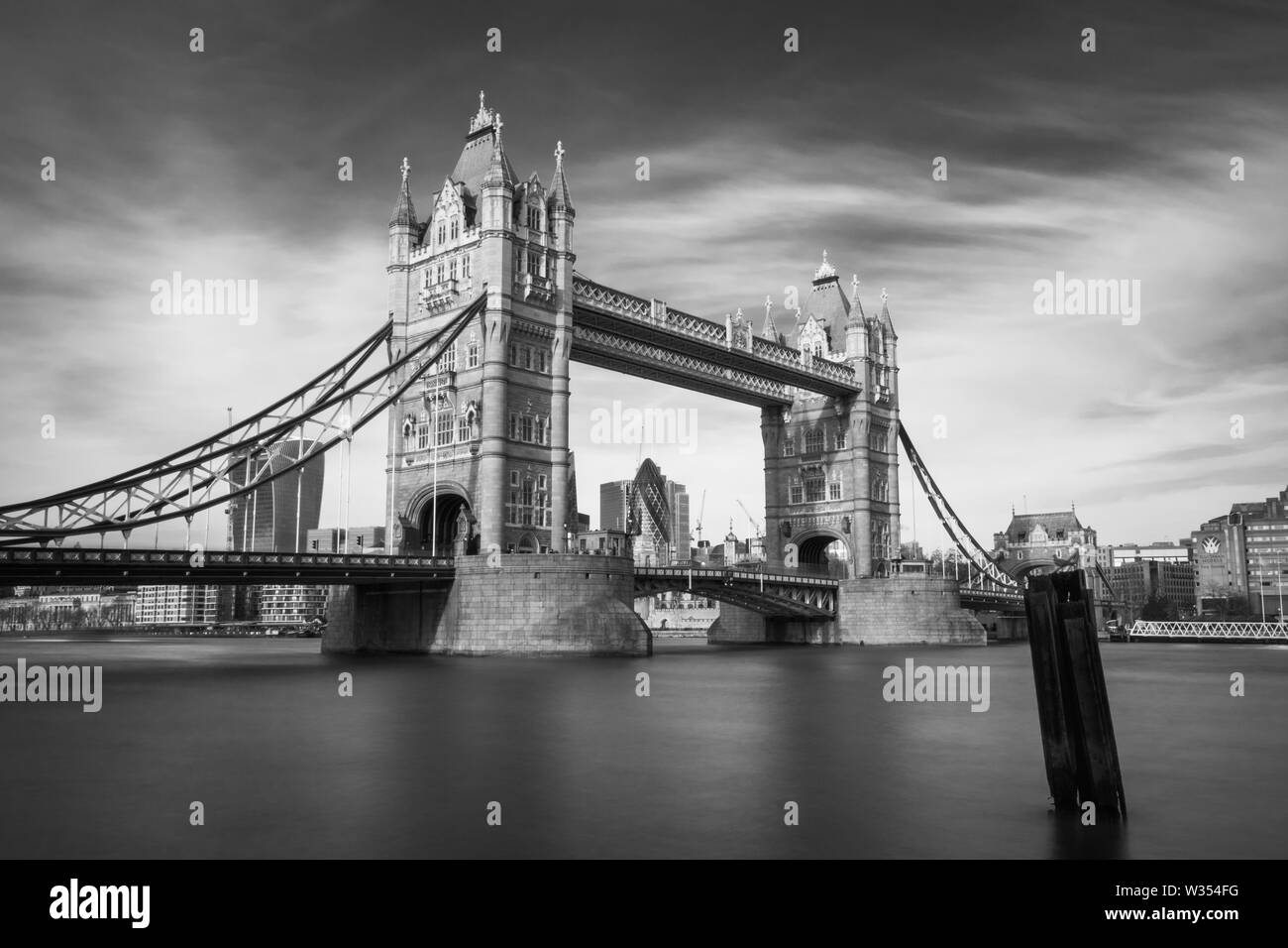 A black and white image of Tower Bridge in London taken with a long exposure Stock Photo