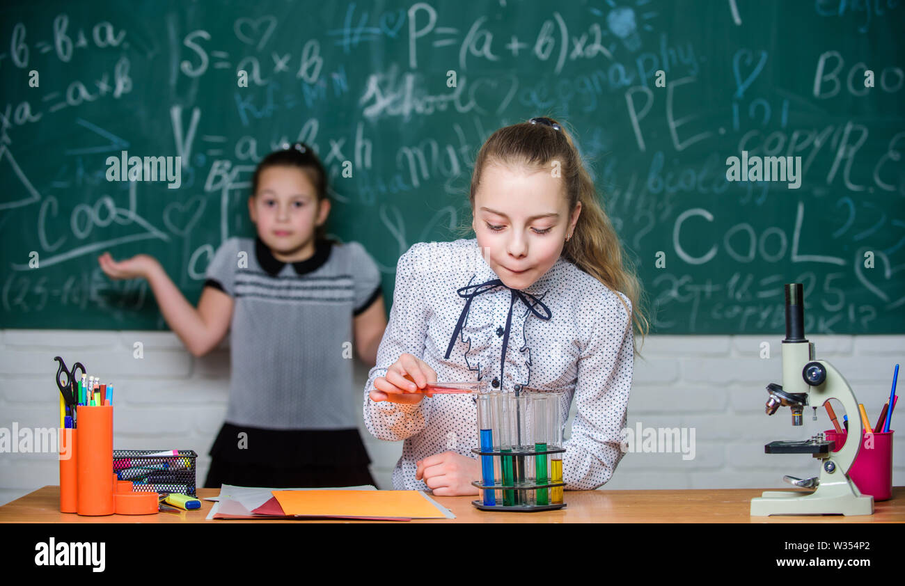 Focusing on work. Chemistry research. Little girls in school lab. Formal school education. Biology school lesson. Little scientist work with microscope. science experiments in laboratory. Stock Photo