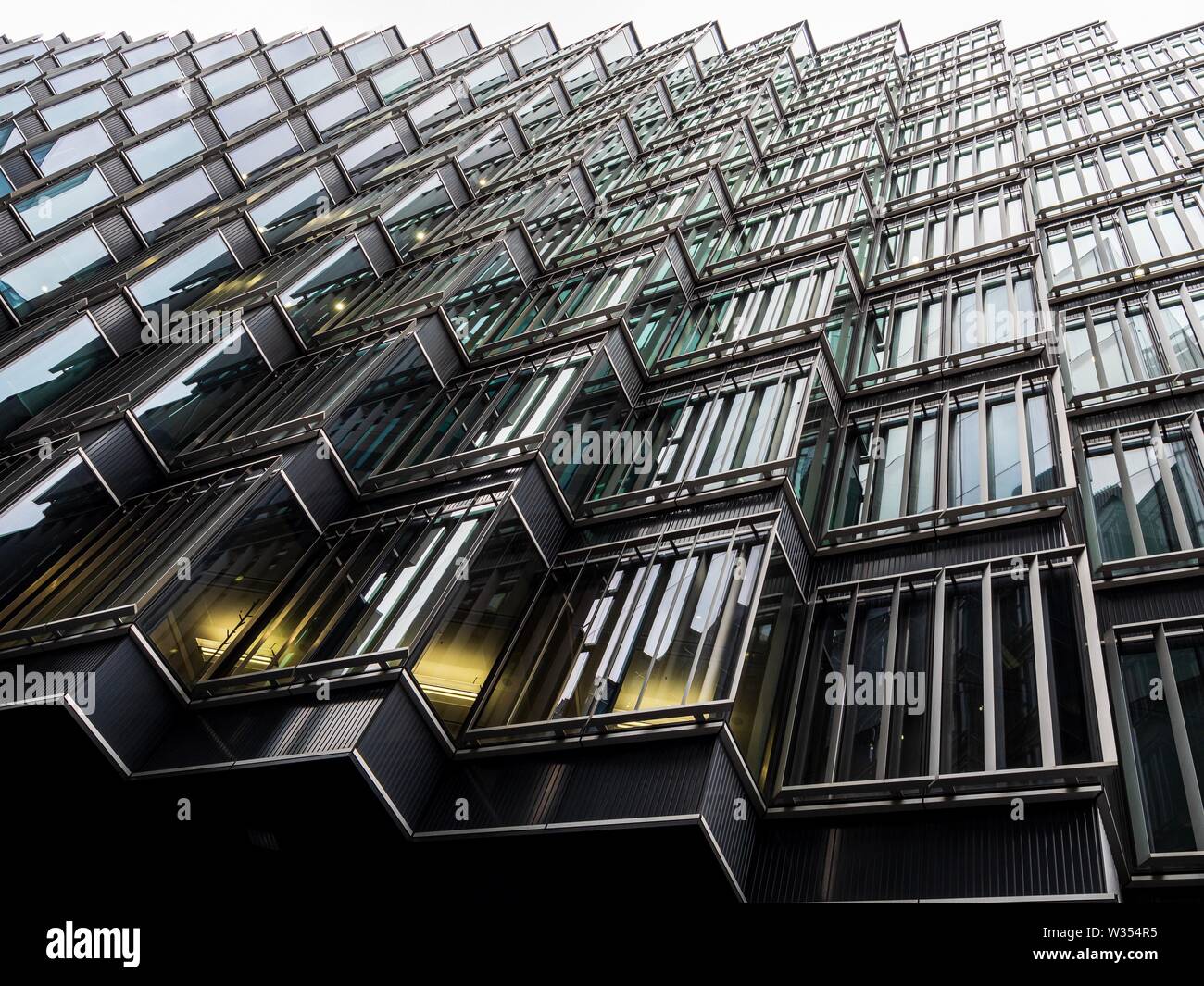 Looking up at the jagged side of a modern office in London on a gloomy day Stock Photo
