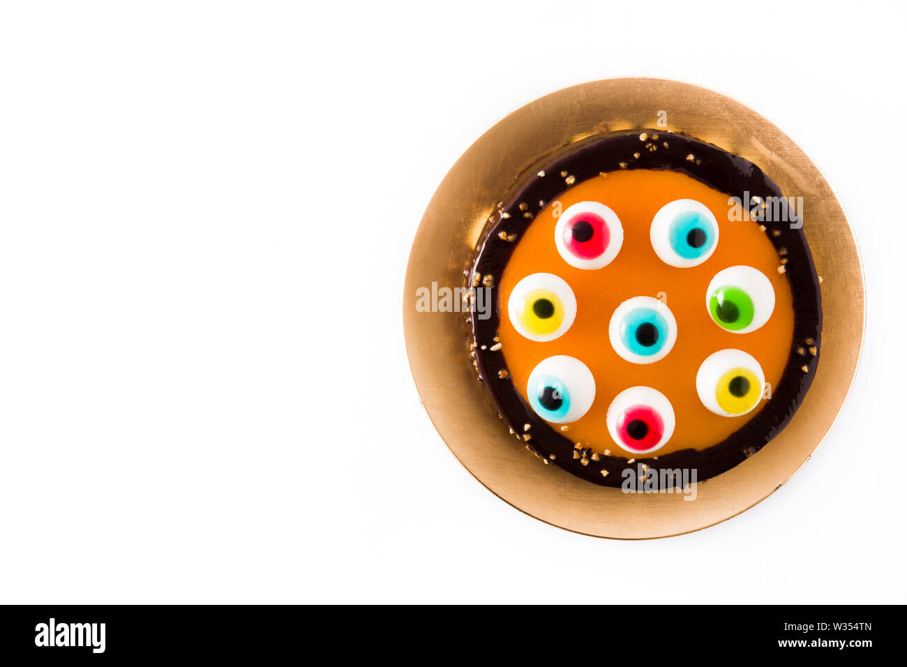 Halloween cake with candy eyes decoration isolated on white background