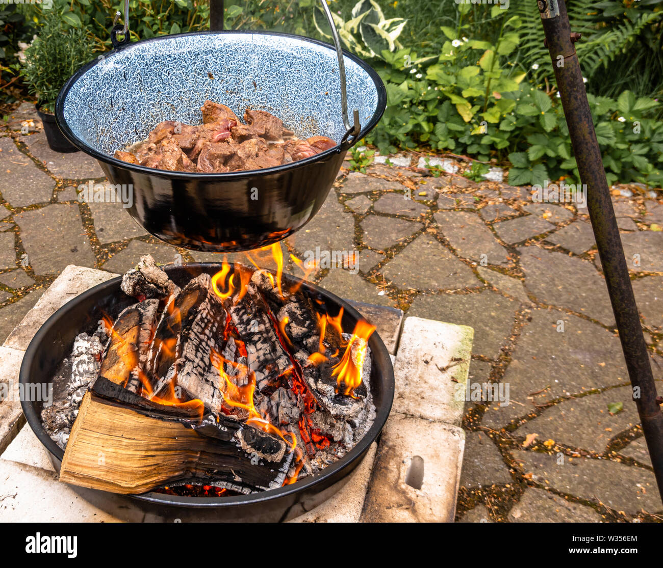 Food cooking in cauldron over fireplace hires stock photography and