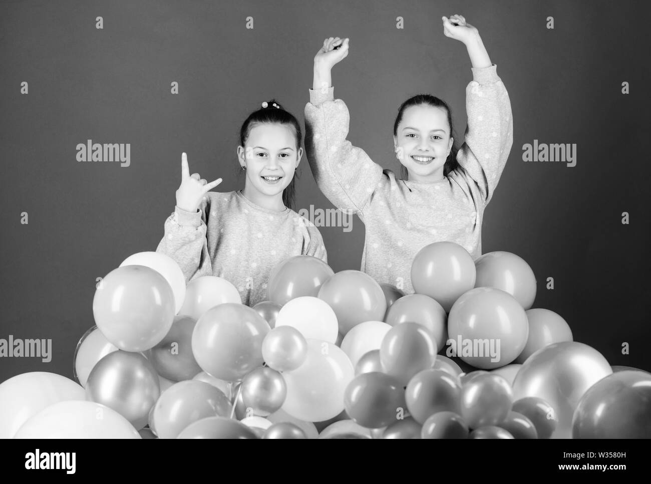 Sisters organize home party. Greeting concept. Having fun concept. Balloon theme party. Girls