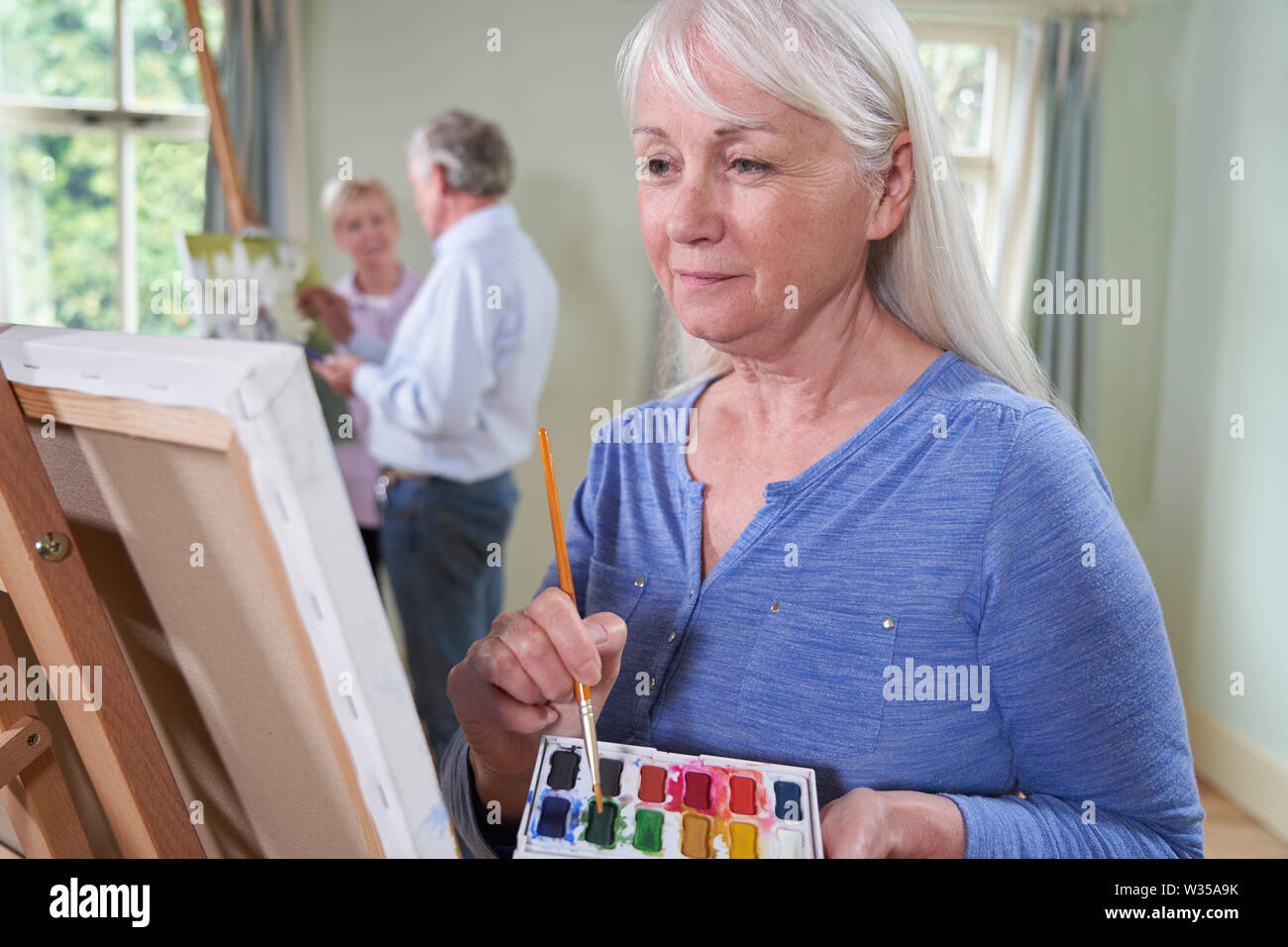 Group Of Seniors Attending Painting Class With Teacher Stock Photo Alamy