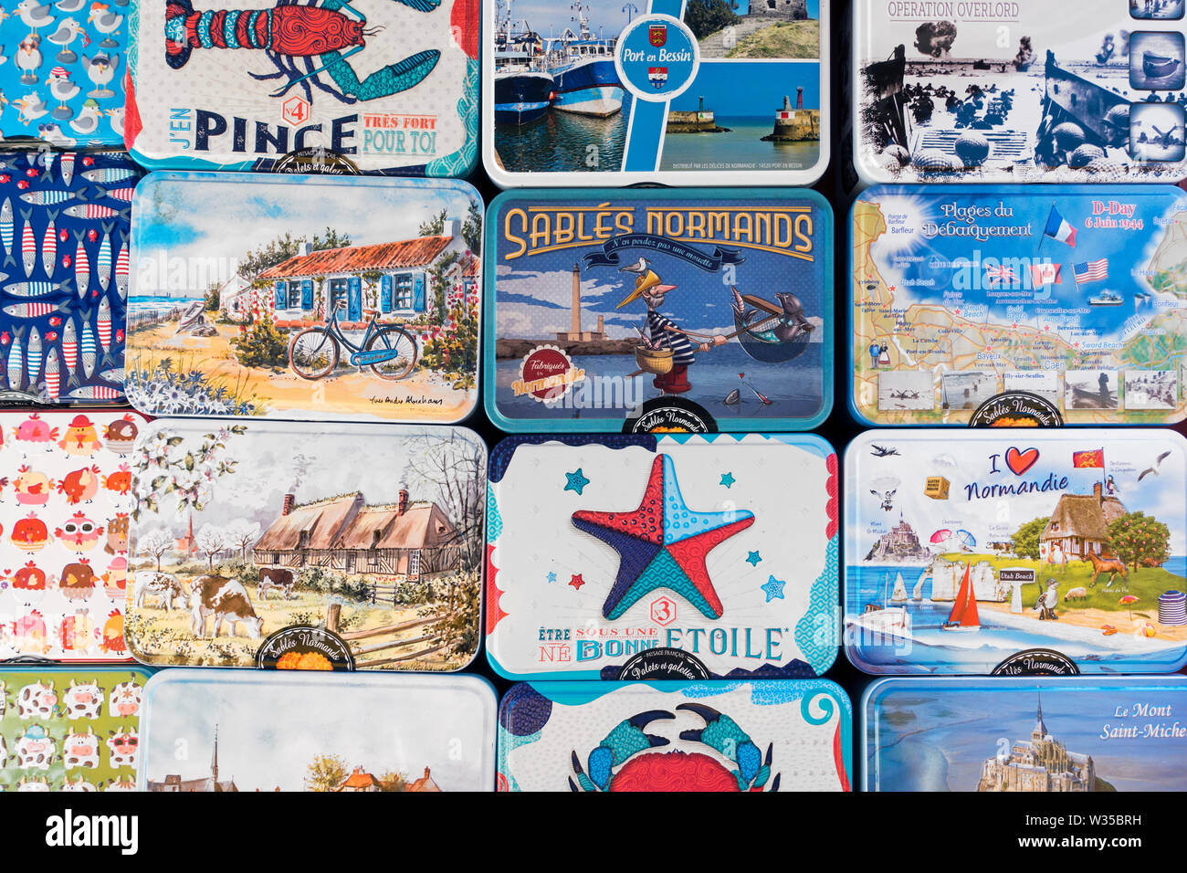 Metal boxes with sablés, French round shortbread cookies as souvenirs on display in souvenir shop at seaside resort Port-en-Bessin, Normandy, France Stock Photo