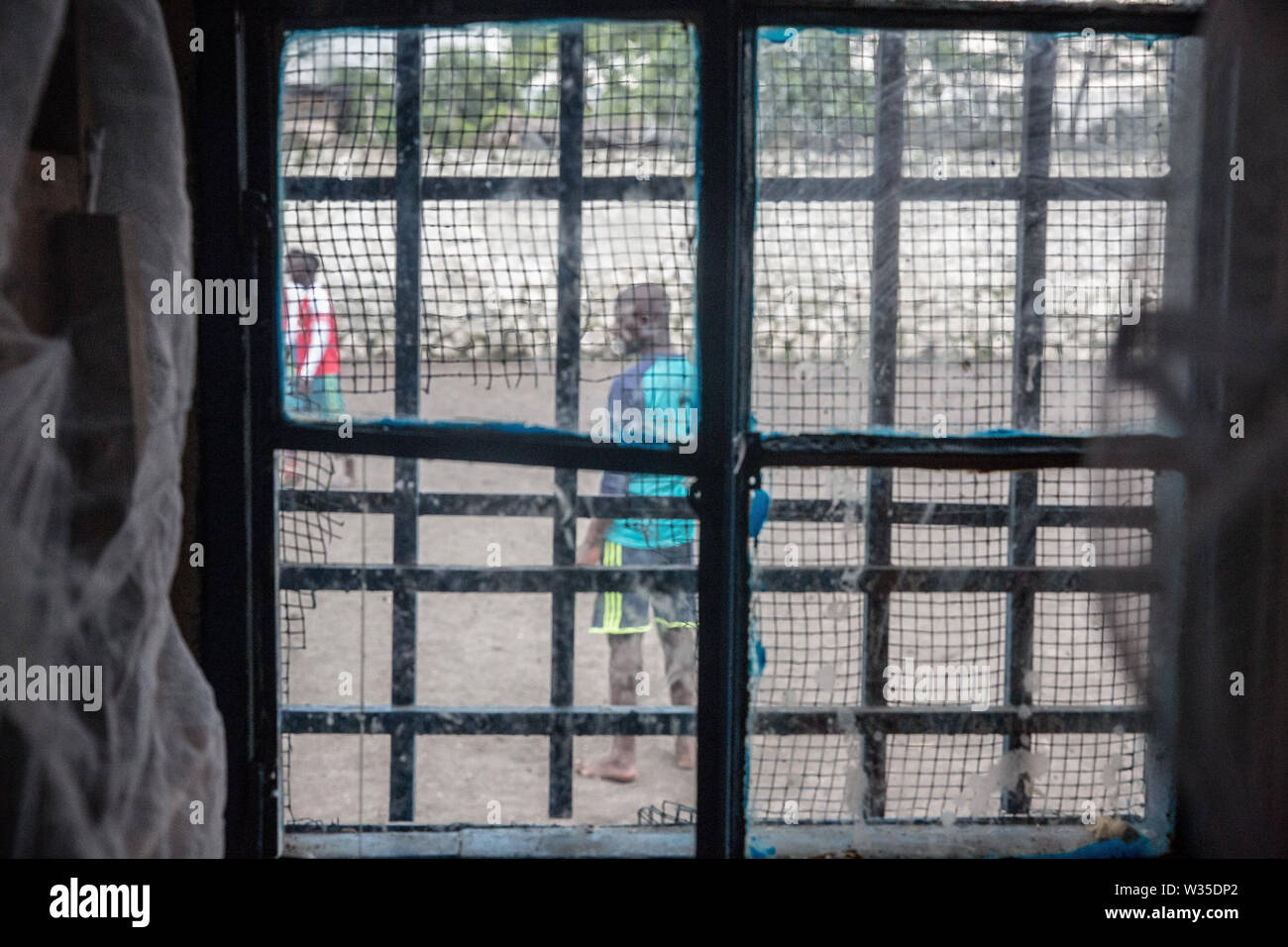 An interior view of a dormitory window at the Transit Centre in Goma. Hundreds will spend several months here before being reintegrated into the community. UNICEF is working with MONUSCO (UN DRC stabilization mission) to support some of the tens of thousands of child soldiers that have been recruited in eastern DRC since 2013. Stock Photo