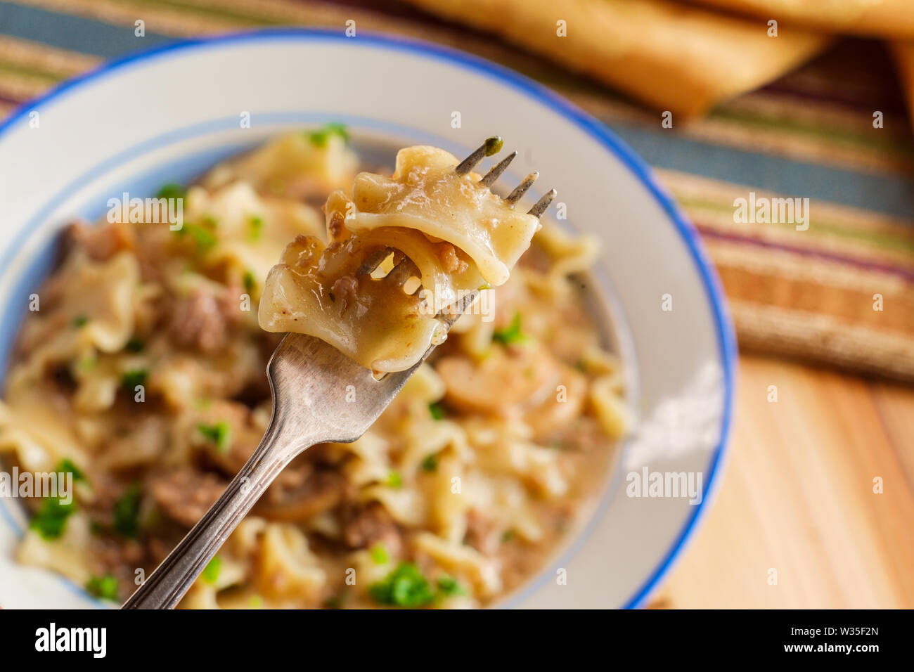 Creamy beef and mushroom stroganoff with egg noodles Stock Photo Alamy
