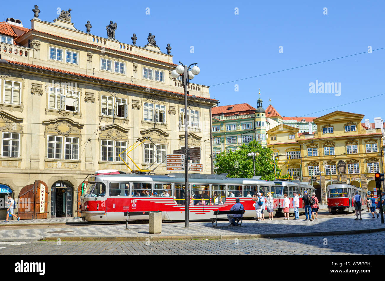 Prague, Czech Republic - June 27th 2019: Streets in historical center of Czech capital in Mala Strana, Lesser Town of Prague. Red tram, public transport, people. Daily life. Praha, Czechia. Stock Photo