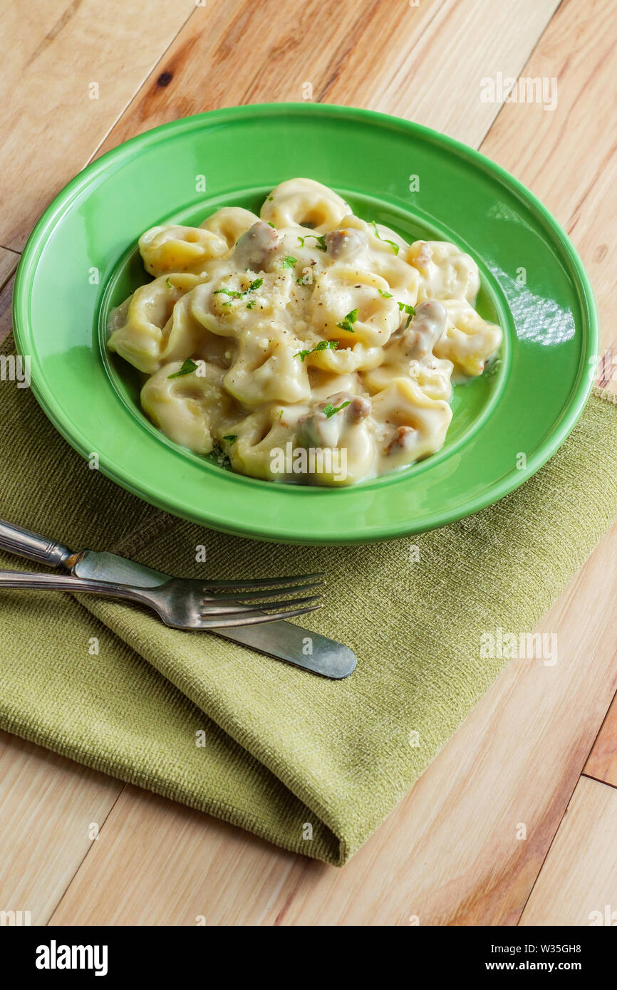 Butter and parmesan cheese tortellini alfredo with Italian sausage Stock Photo Alamy