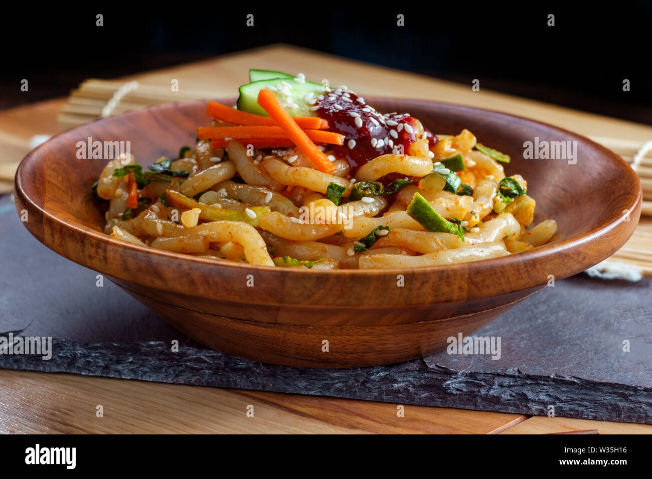 Stirfried kimchi udon noodle bokkeum with fresh kirby cucumber carrots and gochujang suace