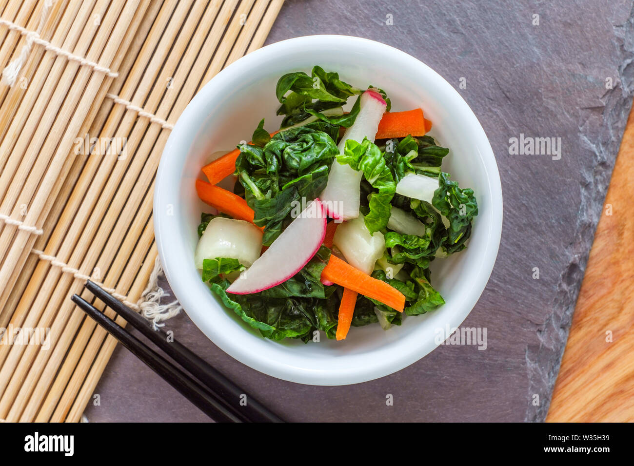 Mild Korean white baek kimchi with radishes julienned carrots and napa