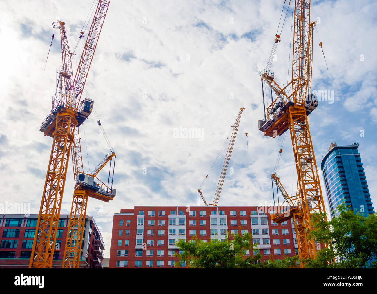 MONTREAL, CANADA - JUNE 17, 2018: Multiple cranes are set up downtown for a large construction project. Stock Photo