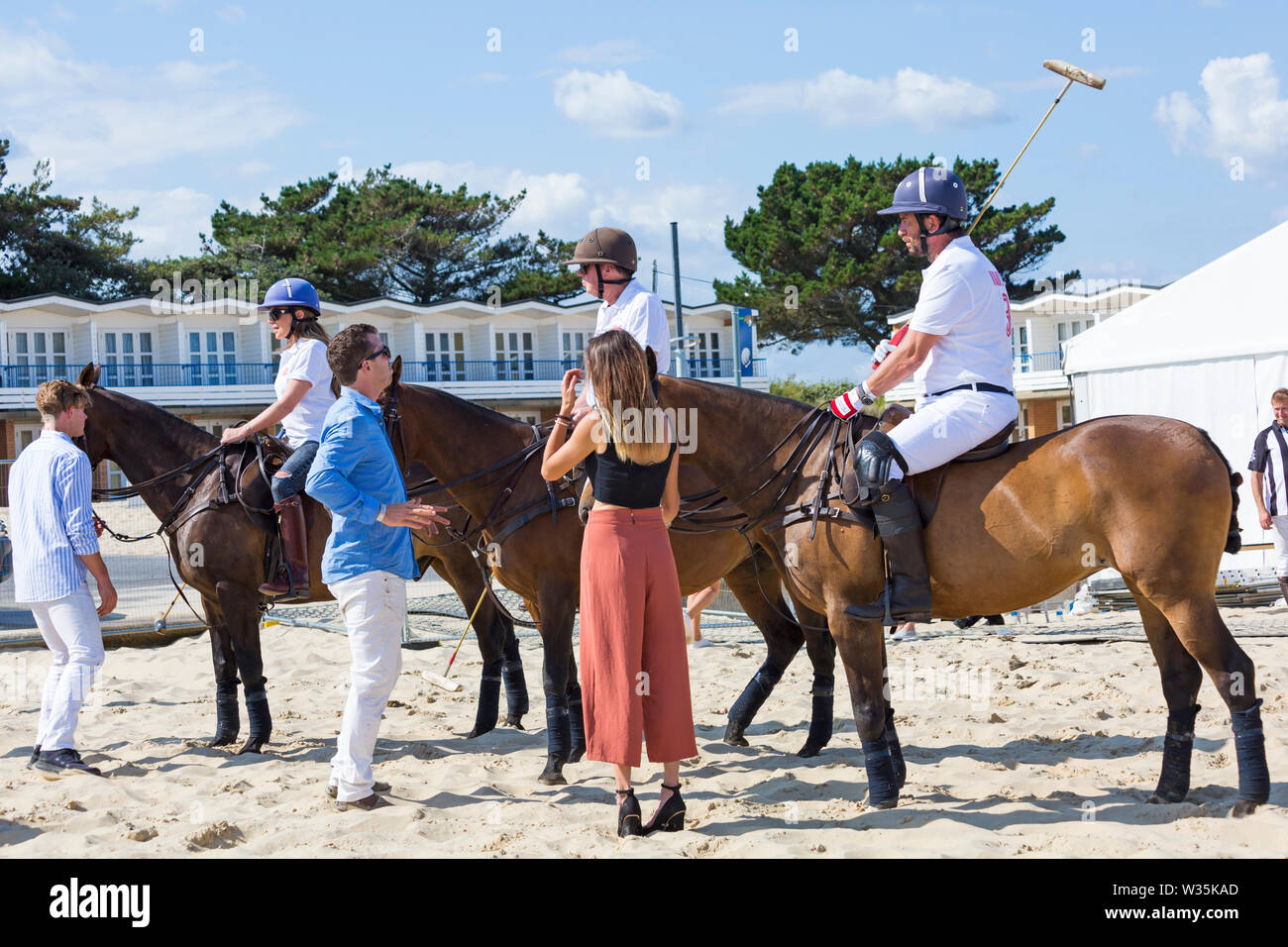 Sandbanks, Poole, Dorset, UK 12th July 2019. The Sandpolo British Beach Polo Championships gets underway at Sandbanks beach, Poole on a warm sunny day. The largest beach polo event in the world, the two day event takes place on Friday and Saturday, as visitors head to the beach to see the action. Nick Knowles, Rita Simons and Harry Redknapp attend for a penalty shoot out. Credit: Carolyn Jenkins/Alamy Live News Stock Photo