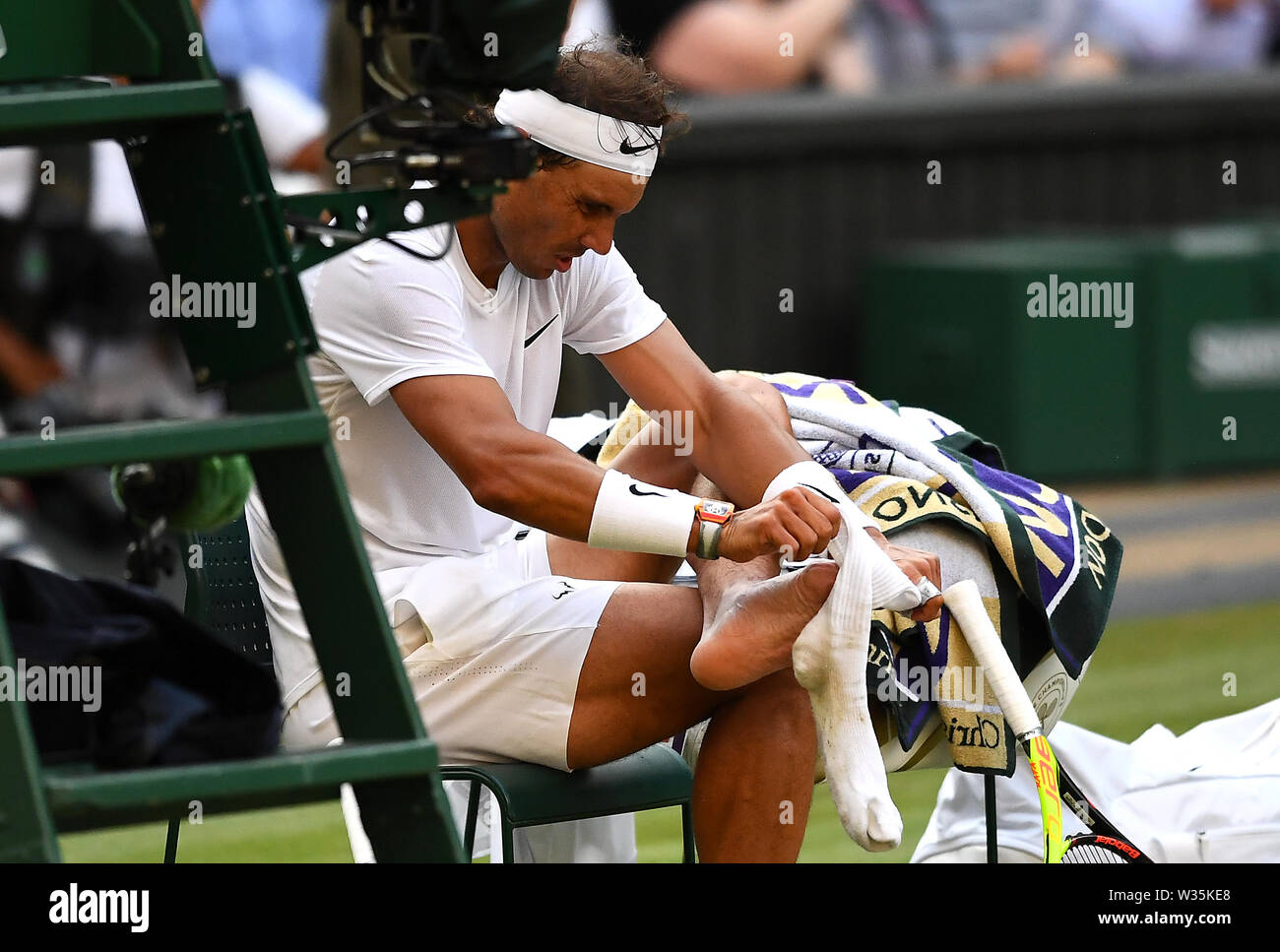 Rafael Nadal changes socks during the Semi-Final match on centre court on  day eleven of the Wimbledon Championships at the All England Lawn Tennis  and Croquet Club, Wimbledon Stock Photo - Alamy