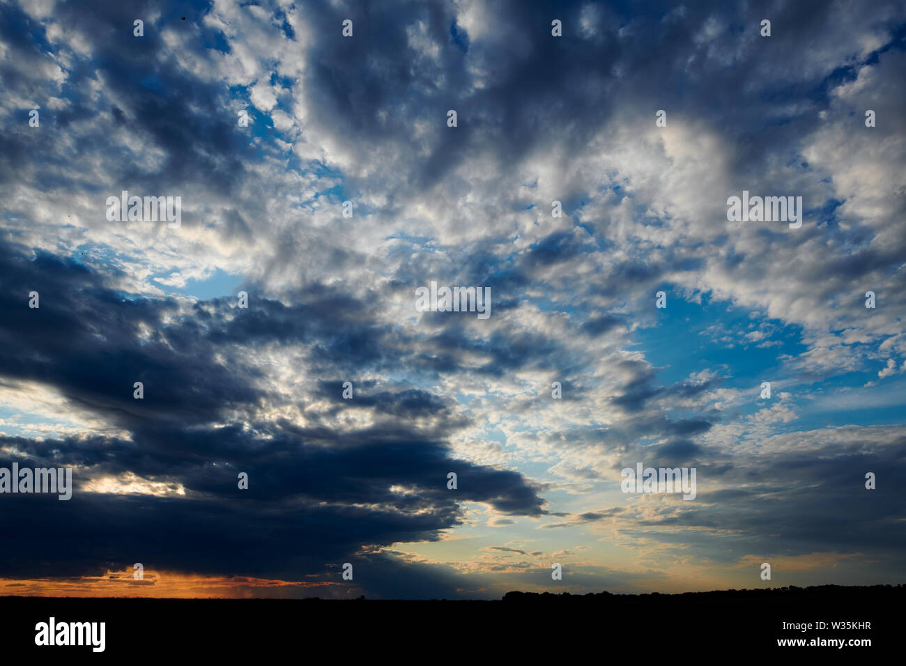 Beautiful sunset - dark sky with clouds and sunlight Stock Photo - Alamy