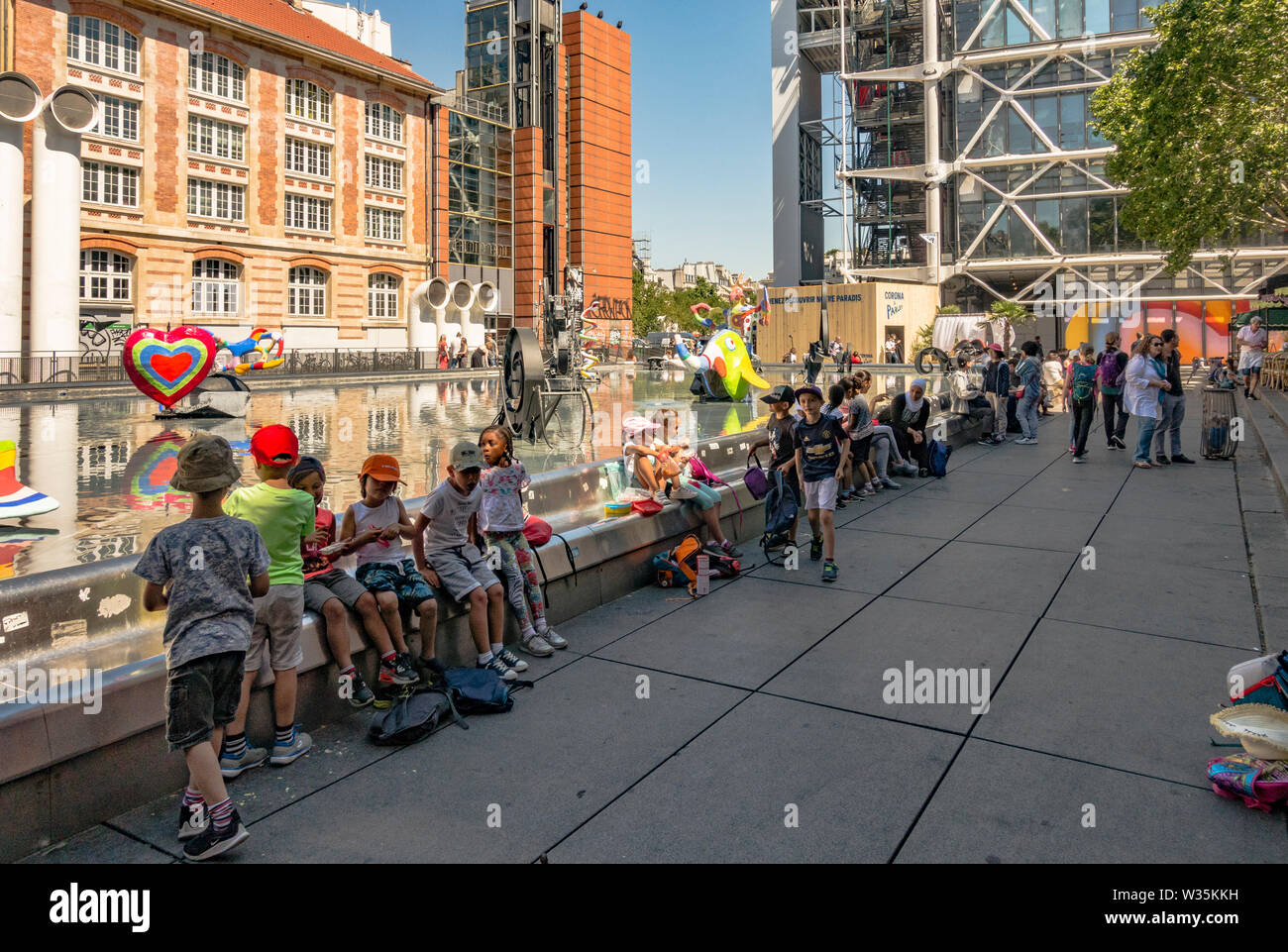 Tourists at Stravinsky Fountain or Fontaine des Automates next to Centre Georges Pompidou museum,. Paris, France. Stock Photo