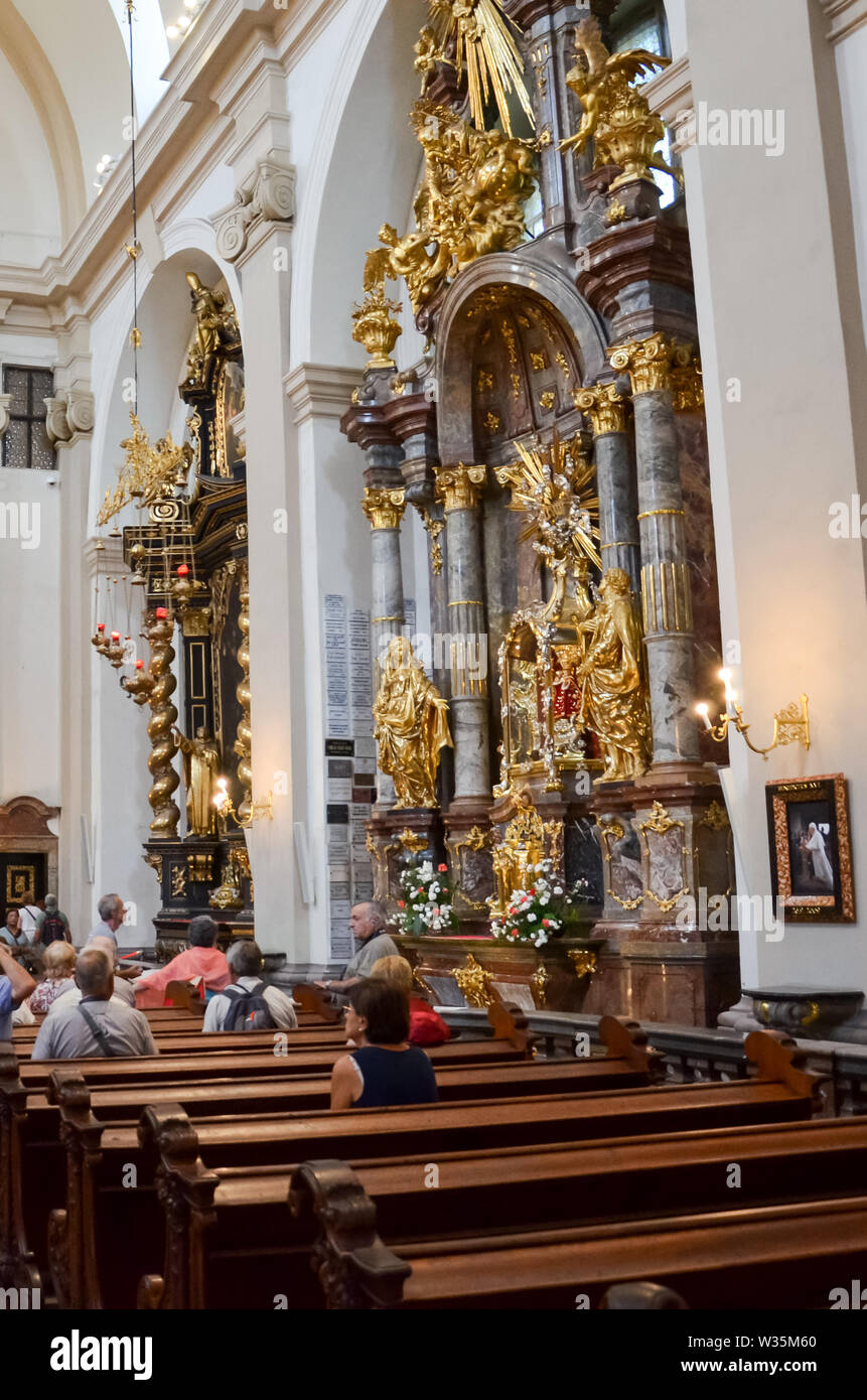 Prague, Czech Republic - June 27 2019: Tourists admiring the Infant Jesus of Prague in the Discalced Carmelite Church of Our Lady Victorious. Religious landmark, Roman Catholic, faith concept. Stock Photo