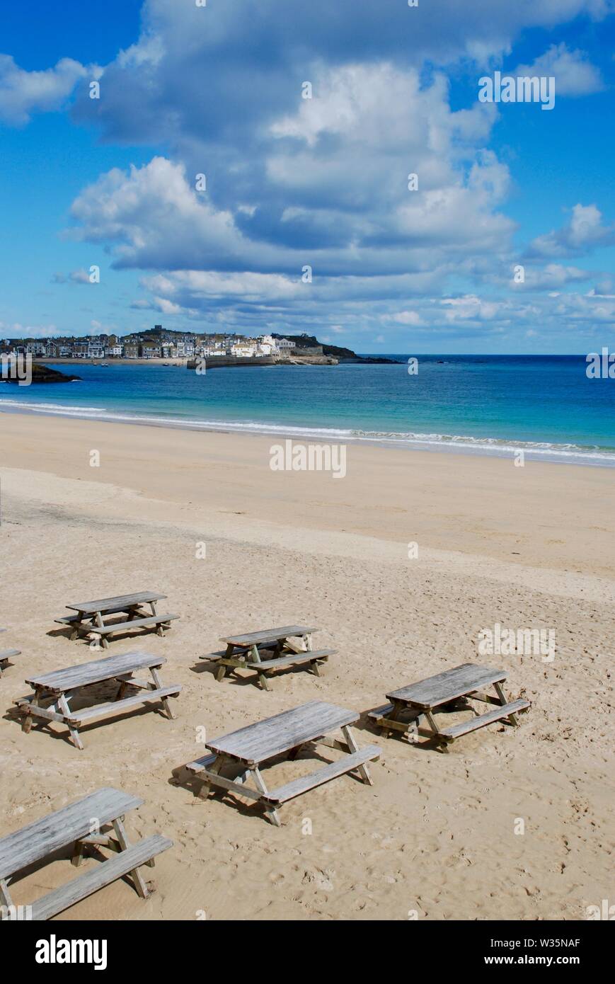 Blue sky and picnic tables on Porthminster Beach, St Ives, Cornwall, UK Stock Photo