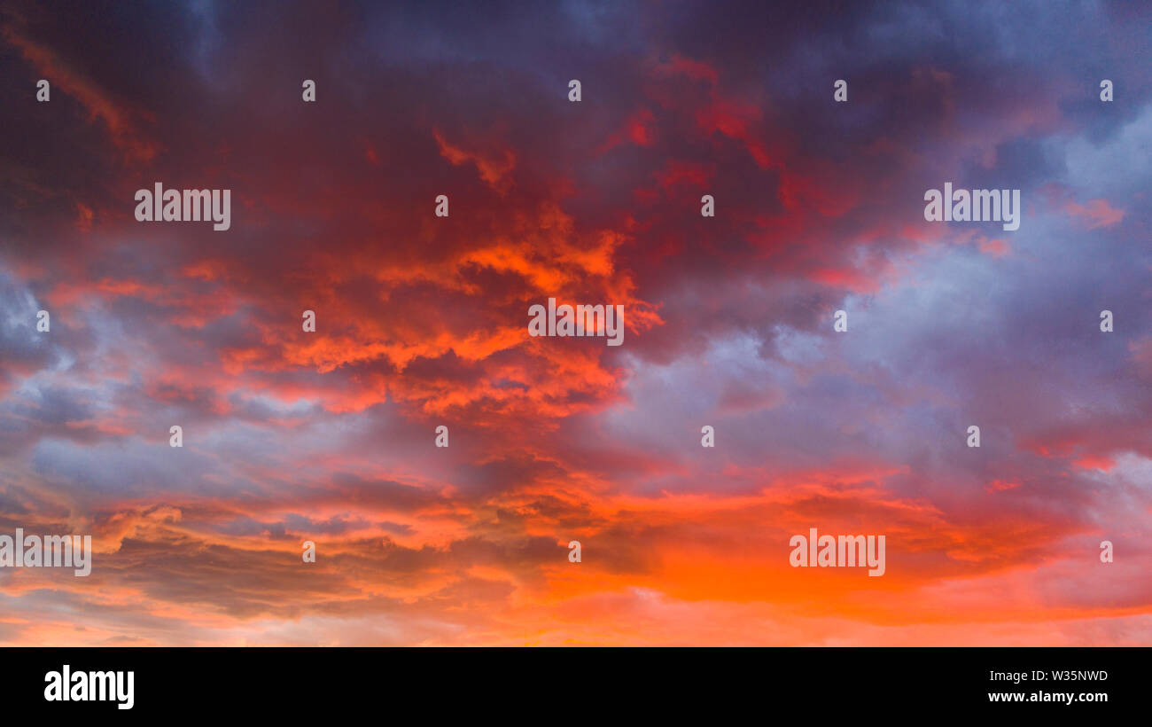 Fire Orange Sunset With Blue Cloud Background Stock Photo - Alamy