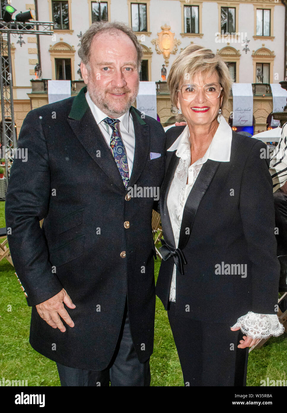 Regensburg, Germany. 12th July, 2019. Gloria von Thurn und Taxis and Harold Faltermeyer, composer, are about to open the Thurn-und-Taxis Castle Festival in the garden of the Princely Castle of St. Emmeram. With a mixture of classical music, pop, rock, musical and theatre, the Schlossfestspiele has been attracting around 30,000 visitors to the Upper Palatinate every year since 2003, according to the figures. Credit: Armin Weigel/dpa/Alamy Live News Stock Photo