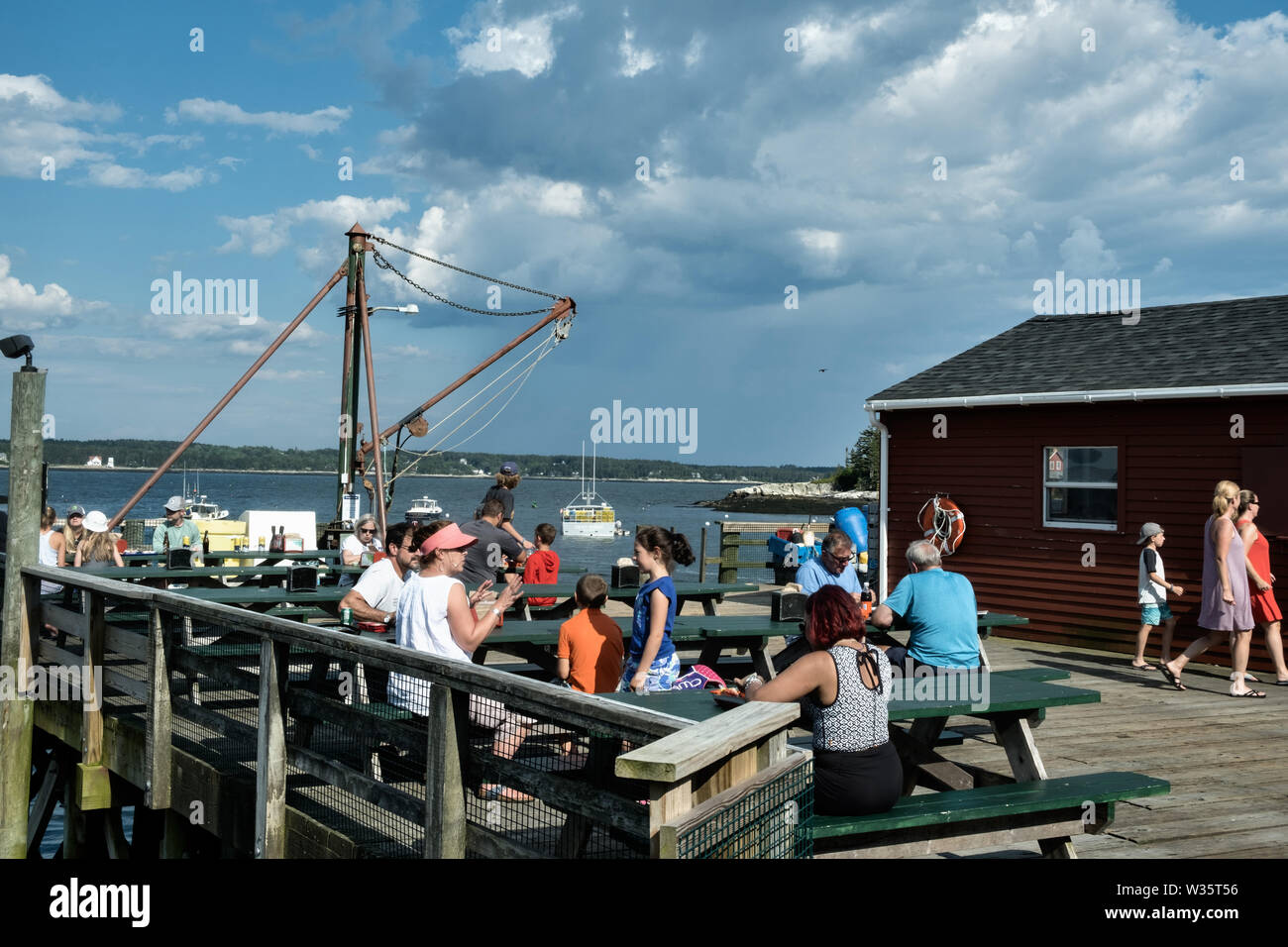 Customers enjoy a lobster meal on the wharf at Five Islands Lobster