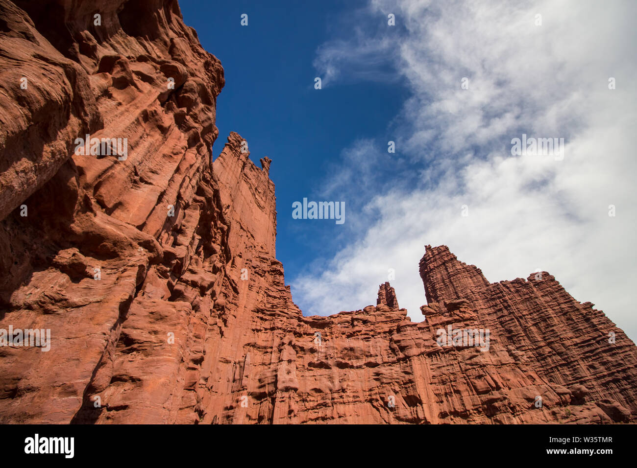 Looking up the red sandstone walls of the Fisher Towers in Utah. Stock Photo