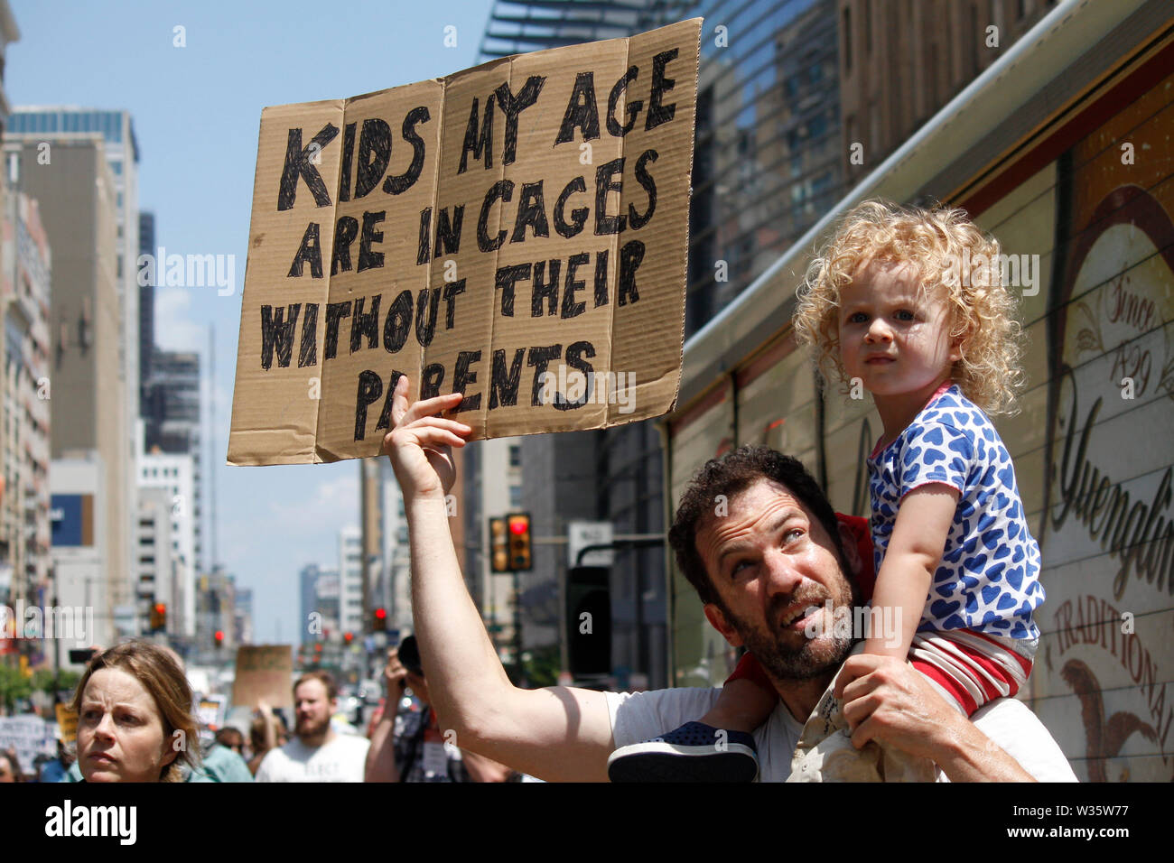Philadelphia, PA, USA - July 12, 2019: A father and child hold a sign  to protest inhumane conditions for children in immigration detention camps. Stock Photo