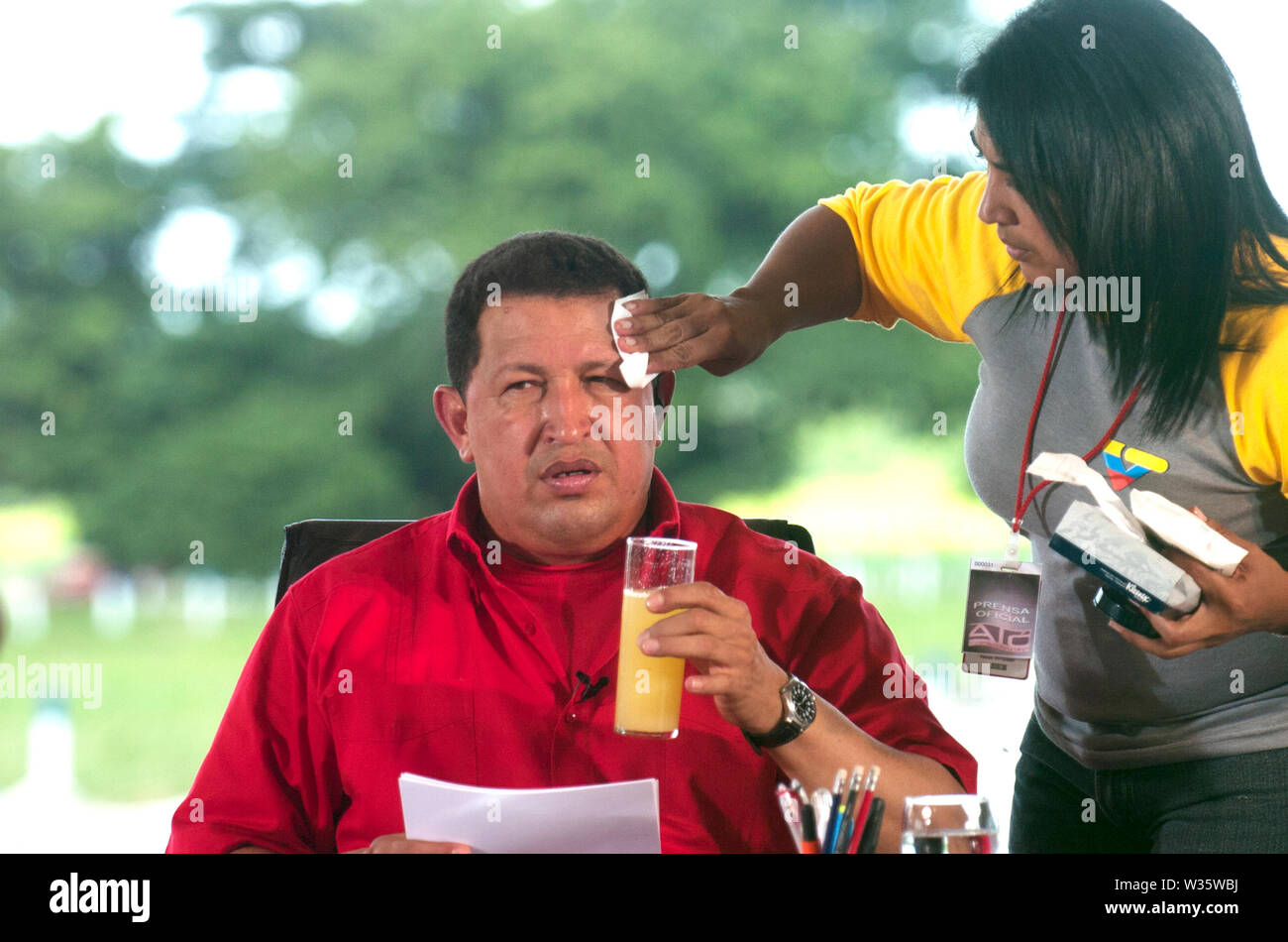 A woman makes up Venezuelan President Hugo Chávez during his tv program Alo Presidente in Barinas, Venezuela Stock Photo