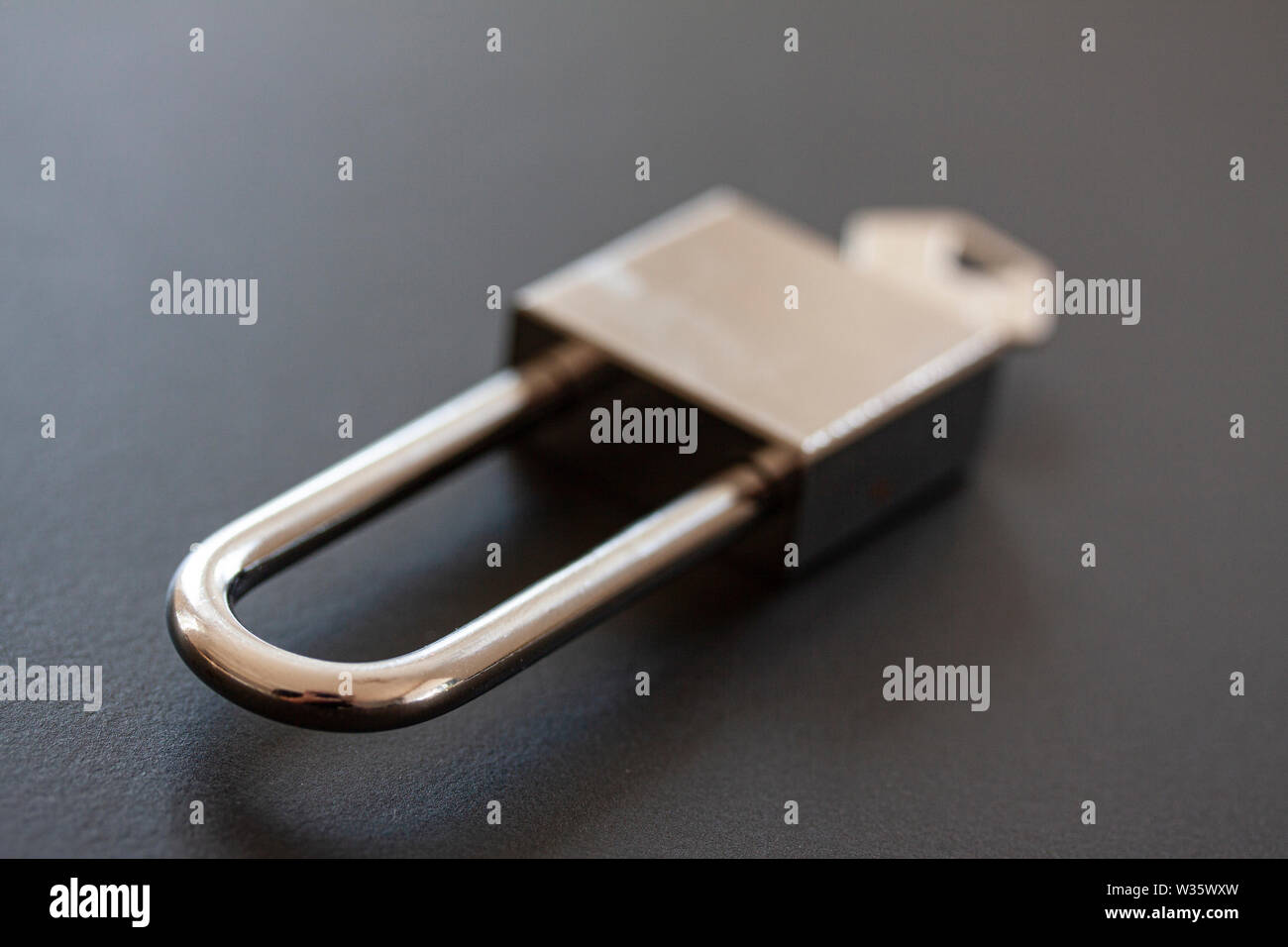 Stainless steel padlock with key on black background - Image Stock ...