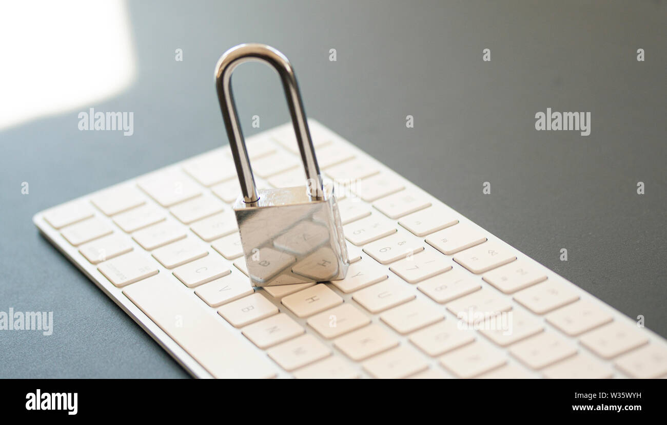 Stainless padlock on computer keyboard. PC network security, data security and antivirus protection concept. - Image Stock Photo