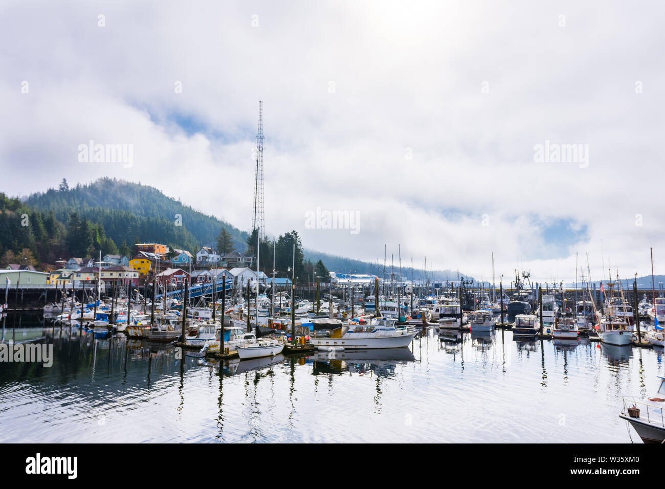 Calm morning landscape of harbor piers brimming with fishing boats, Ketchikan, Alaska, USA Stock Photo