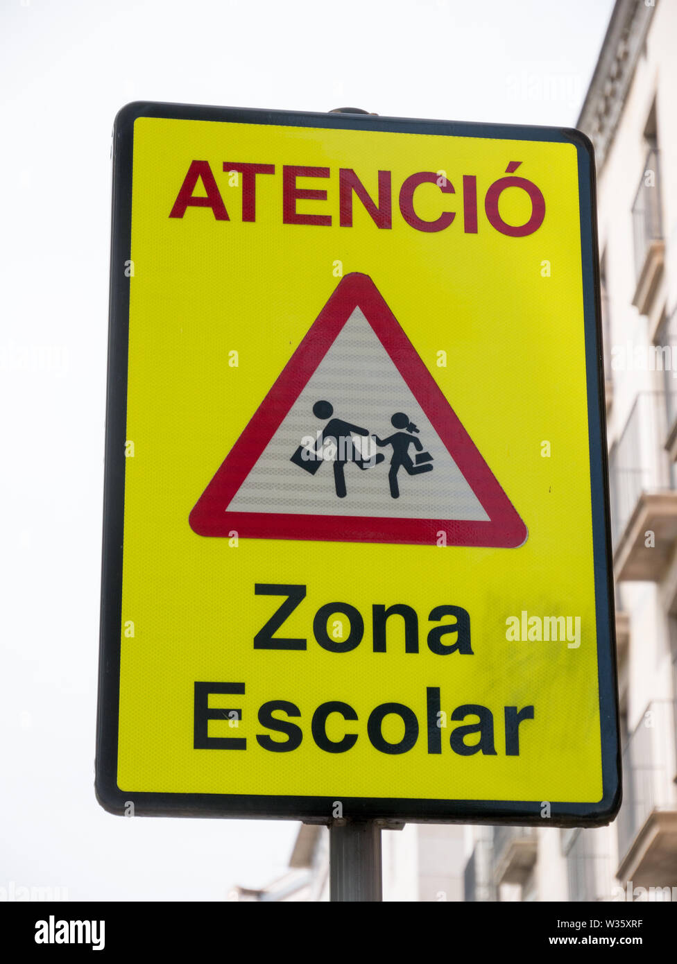 A yellow warning sign "Zona Escolar" in spanish mean "School Zone" in