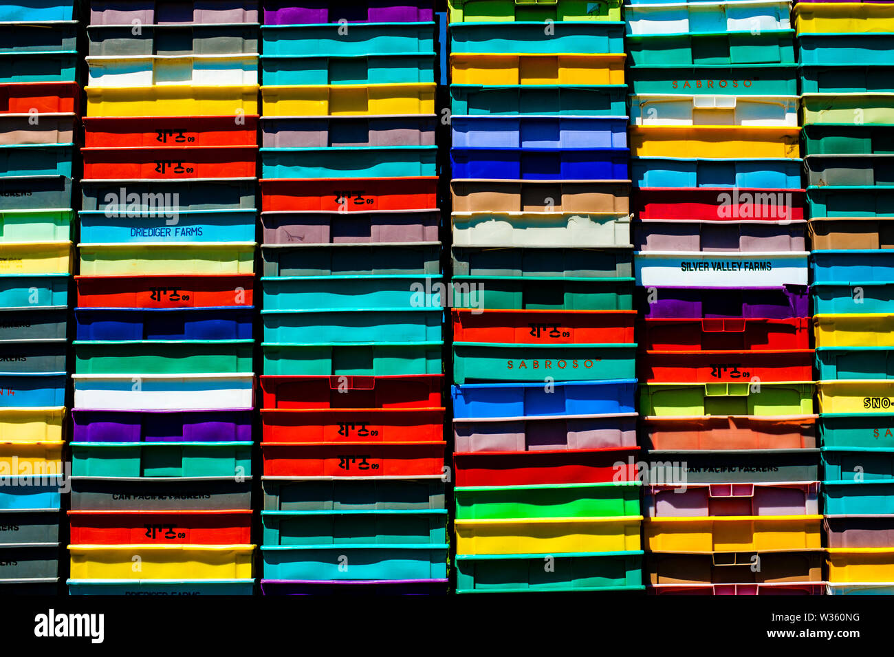 Stack of multicolored plastic crates Stock Photo - Alamy