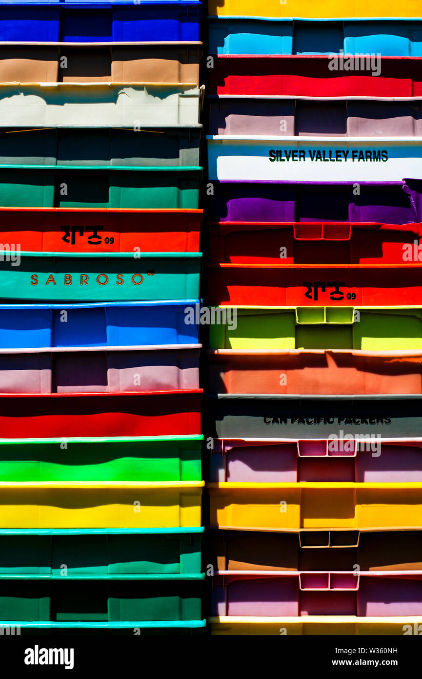 Stack of multicolored plastic crates. Stock Photo