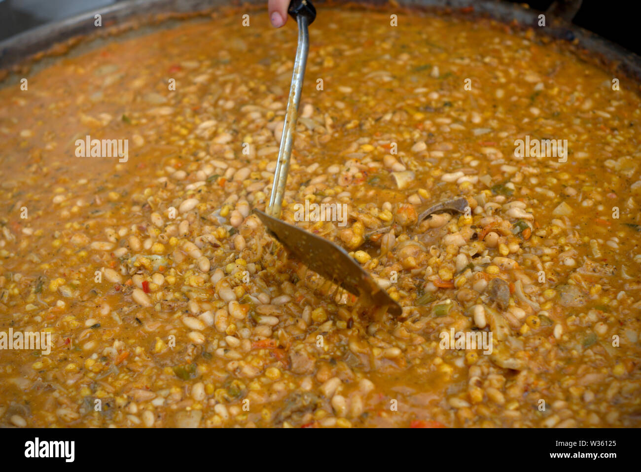 Close up of a large casserole of locro, a traditional argentinian stew made mainly with beans and sweet corn. Stock Photo