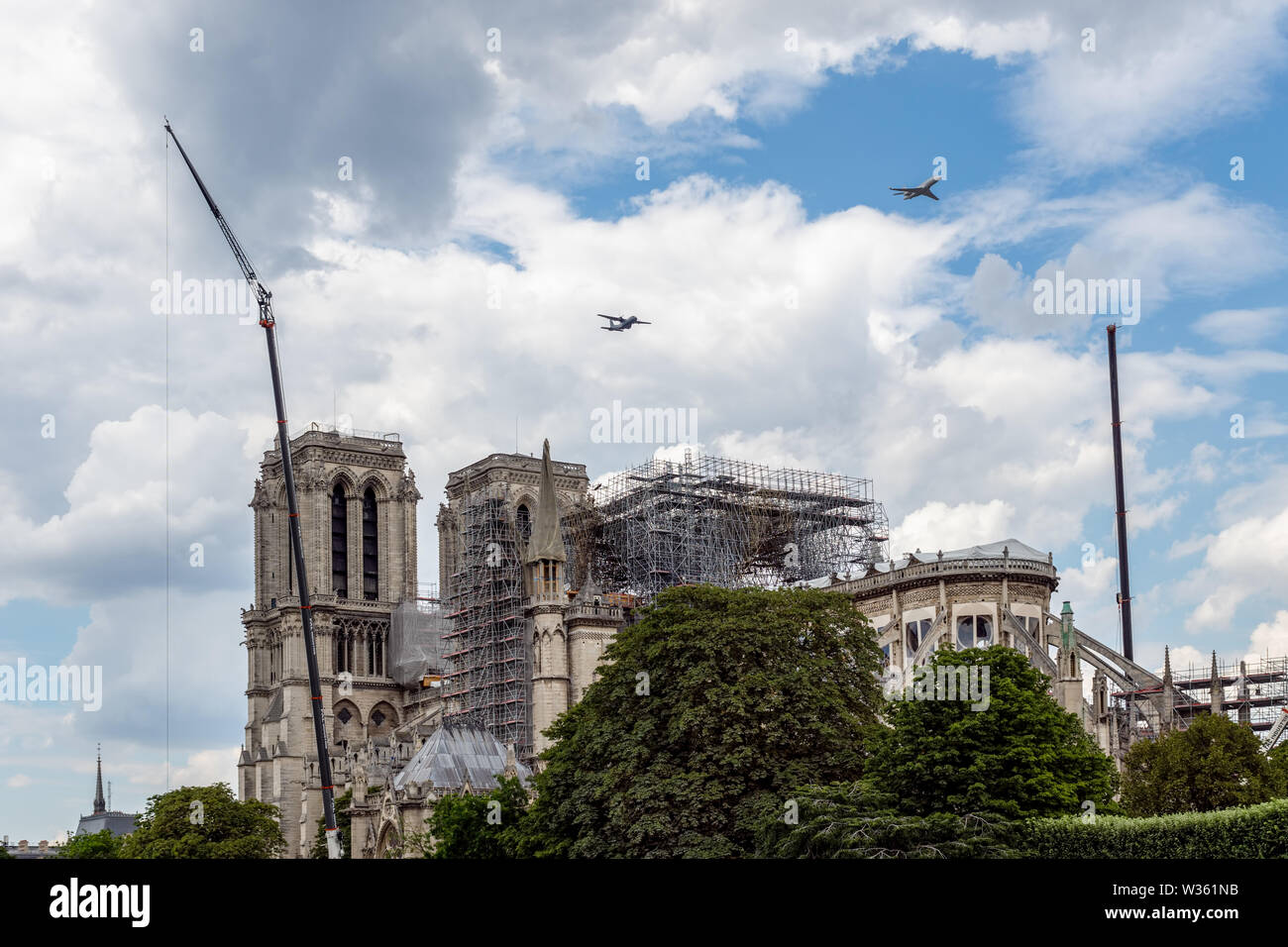 French military aircrafts flying over Notre Dame de Paris Stock Photo