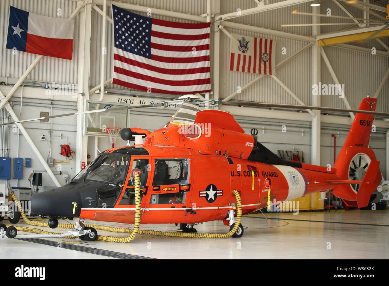 An MH-65 Dolphin helicopter sits at the ready to respond to Tropical Depression Barry at Coast Guard Air Station Houston July 11, 2019. The Coast Guard is pre-staging response assets in the Gulf Coast region due to a forecast of a tropical storm and possible hurricane. (U.S Coast Guard photo by Petty Officer 3rd Class Paige Hause) Stock Photo