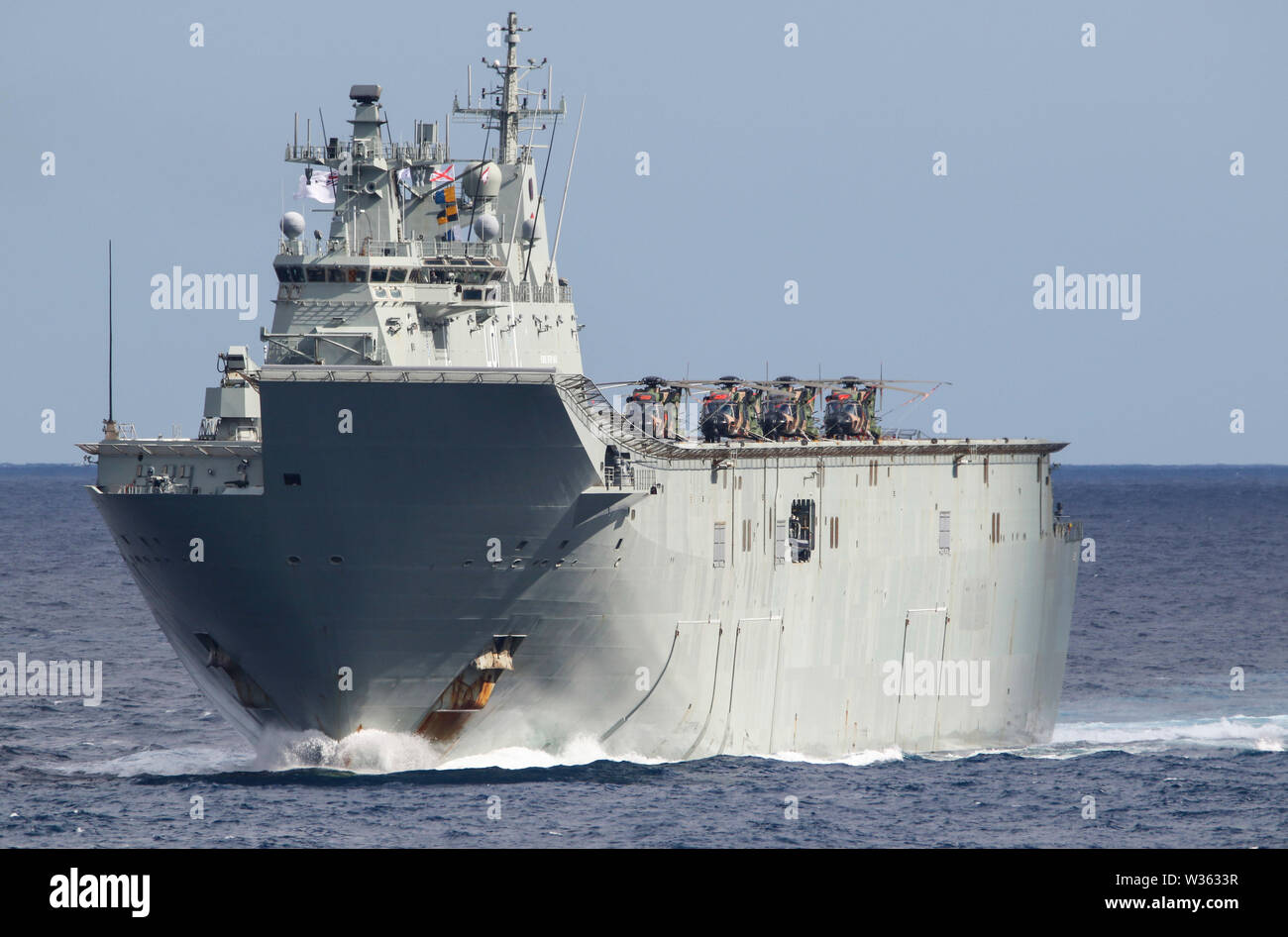 190711-N-DX072-1044 TASMAN SEA (July 11, 2019) The Royal Australian Navy Canberra-class landing helicopter dock ship HMAS Adelaide (L01) transits with the amphibious transport dock ship USS Green Bay (LPD 20) in a photo exercise (PHOTOEX) during Talisman Sabre 2019. Green Bay, part of the Wasp Expeditionary Strike Group, with embarked 31st Marine Expeditionary Unit, is currently participating in Talisman Sabre 2019 off the coast of Northern Australia. A bilateral, biennial event, Talisman Sabre is designed to improve U.S. and Australian combat training, readiness and interoperability through r Stock Photo