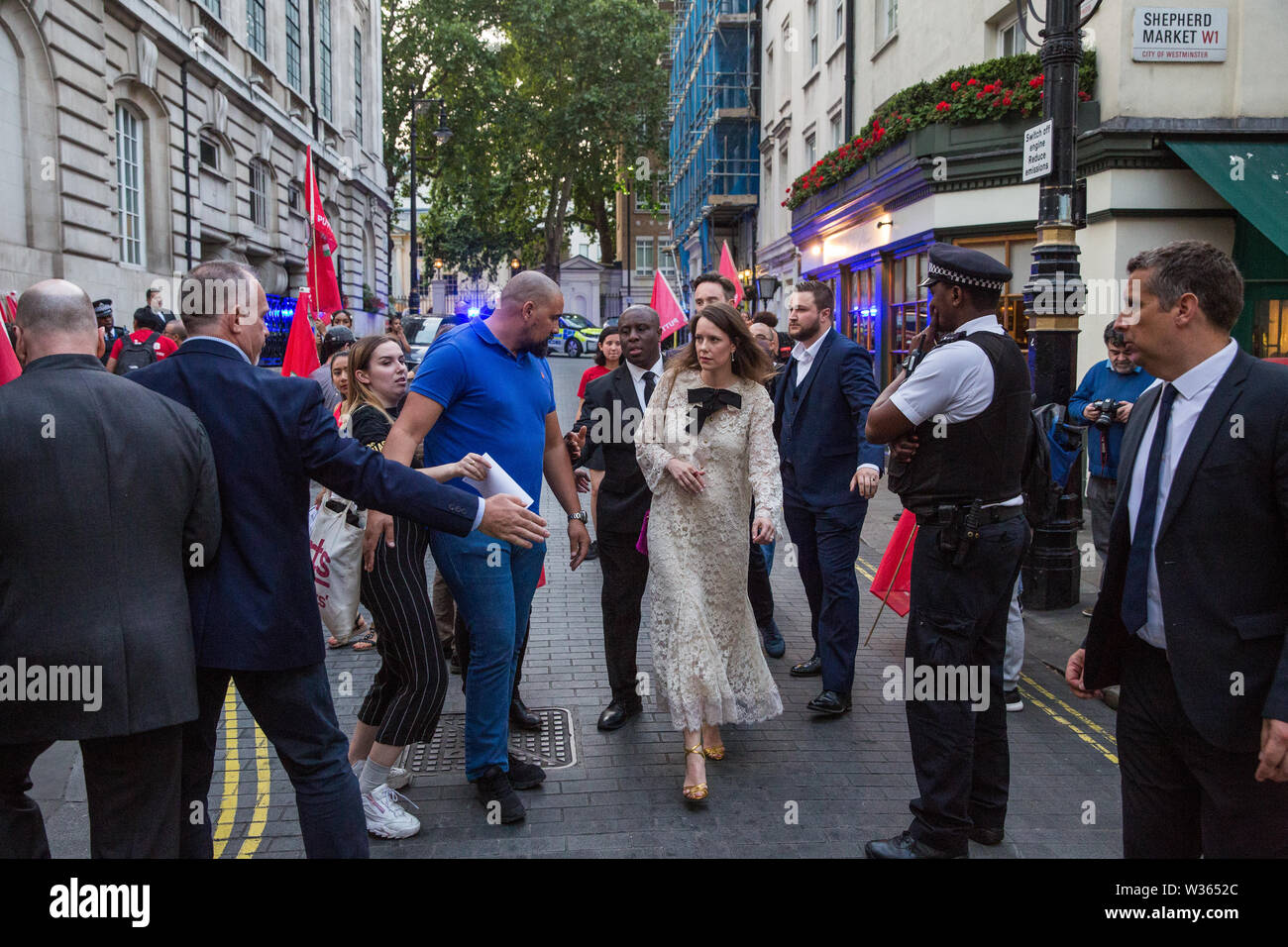 London, UK. 12 July, 2019. Members of the Cleaners and Facilities Branch of the IWGB (Independent Workers of Great Britain) trade union urge guests not to enter 5 Hertford Street in Mayfair, which also houses exclusive private club Loulou’s, during a protest to call for its kitchen porters, recently outsourced through ACT, to be paid the London Living Wage and given terms and conditions including suitable sick pay, holidays and pension contributions. Numerous unmarked security guards were present outside the venue. Credit: Mark Kerrison/Alamy Live News Stock Photo