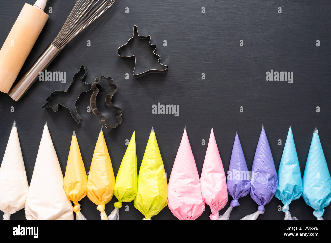 Flat lay. Variety of colors of royal icing in plastic piping bags Stock