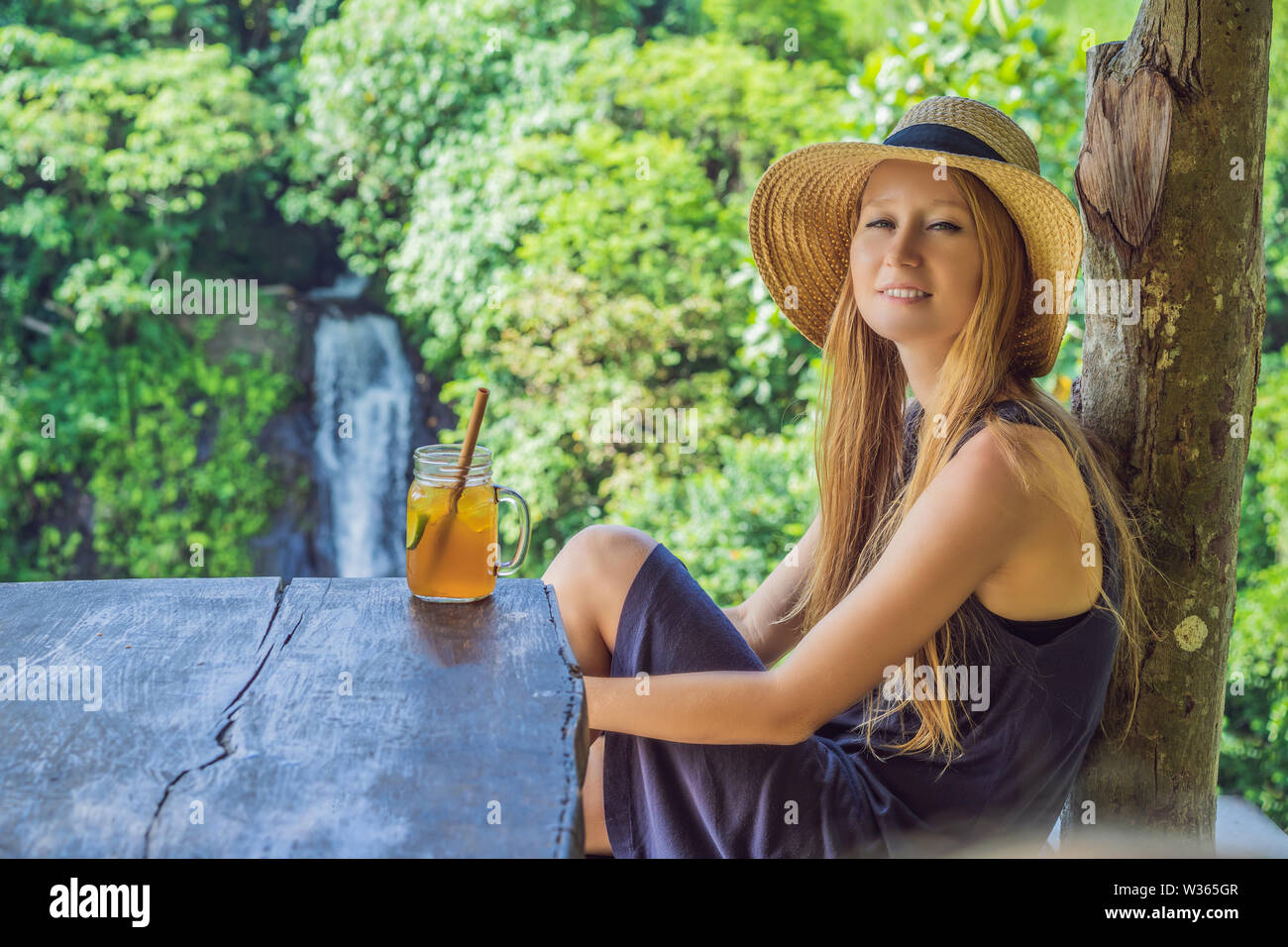 Closeup portrait image of a beautiful woman drinking ice tea with ...