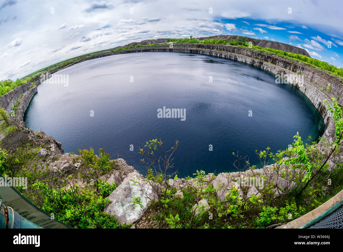 Wide angle panorama view of Marmora mine blue hole showing rocky wall