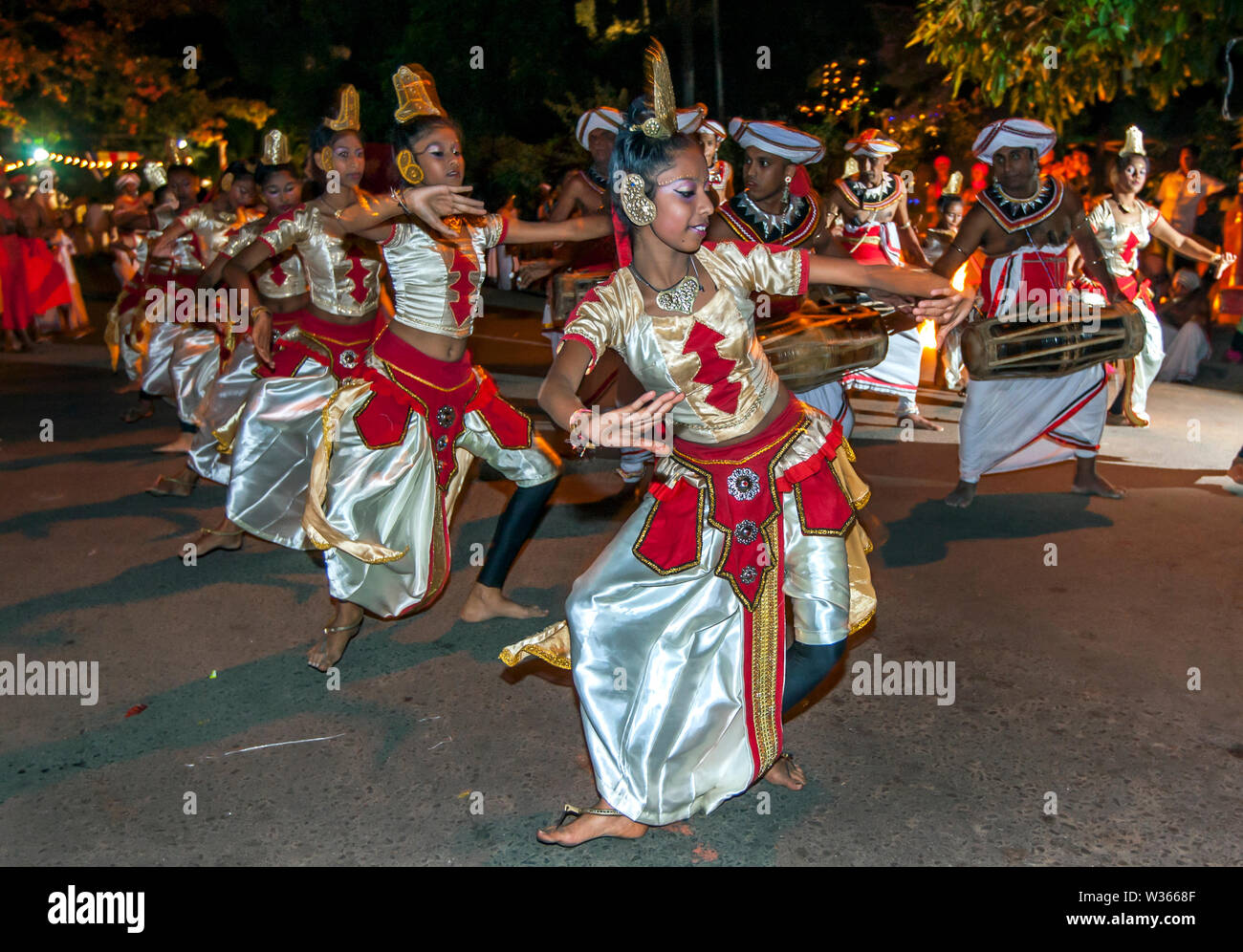 Female dancers perform in the Esala Perahara (procession) at Kandy in