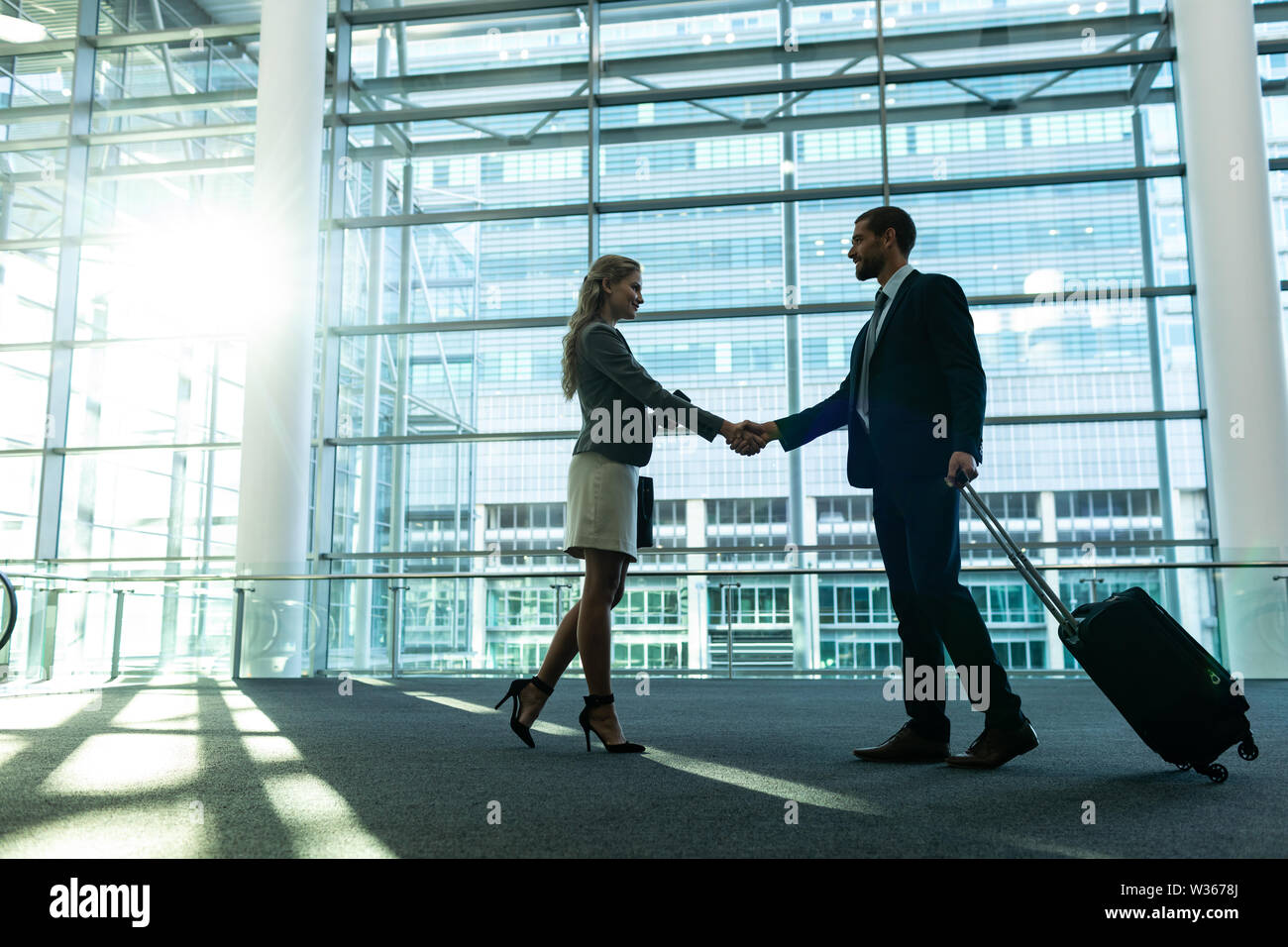 Business people shaking hands in the modern office building Stock Photo ...