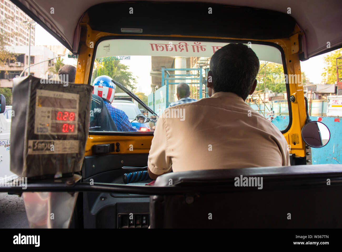 Mumbai, Maharashtra, india - JUNE 4th, 2019 : Inside view of auto-rickshaw driver driving on streets of Mumbai traffic - Image Stock Photo