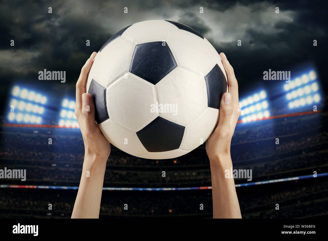 Woman holding soccer ball inside stadium Stock Photo Alamy
