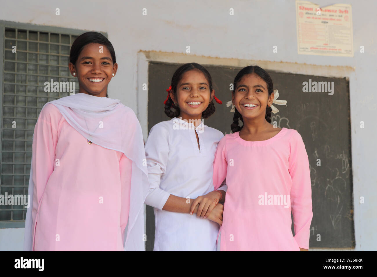 Schoolgirls smiling in a school Stock Photo - Alamy