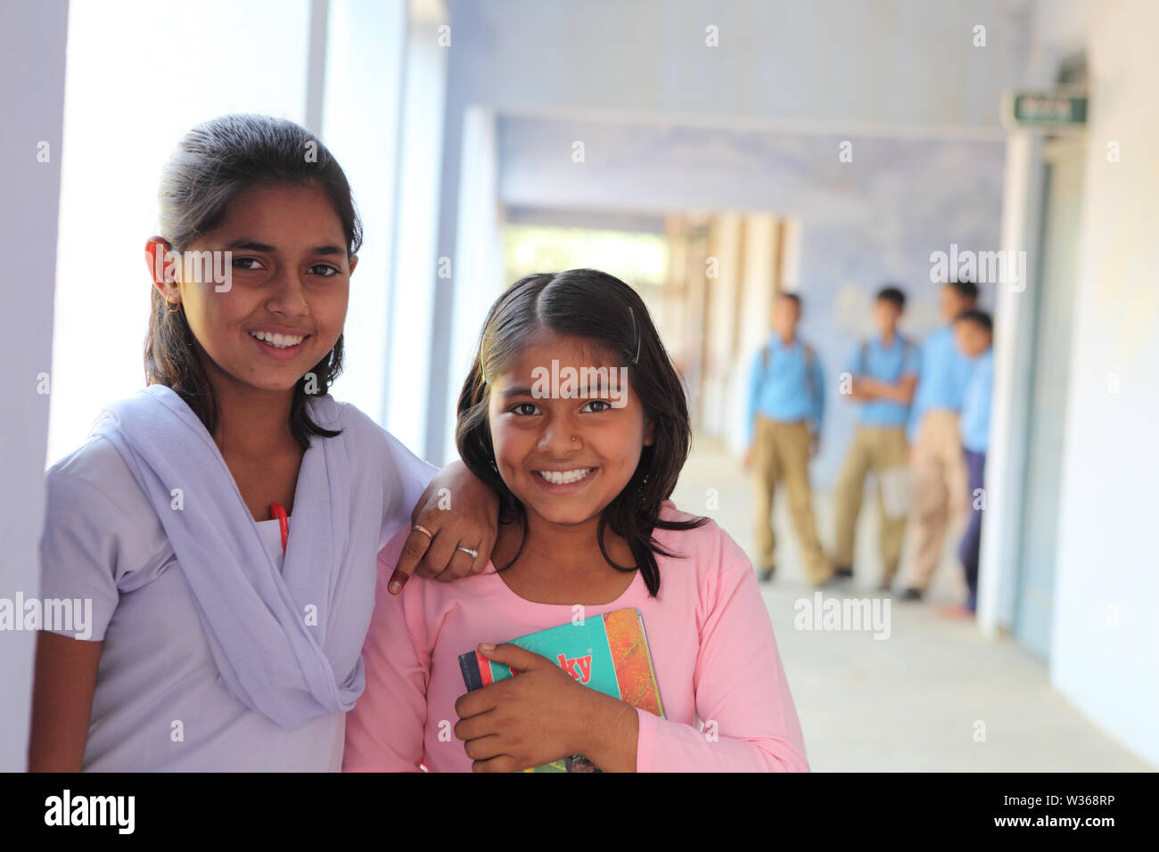 Portrait of two schoolgirls smiling in a school Stock Photo - Alamy