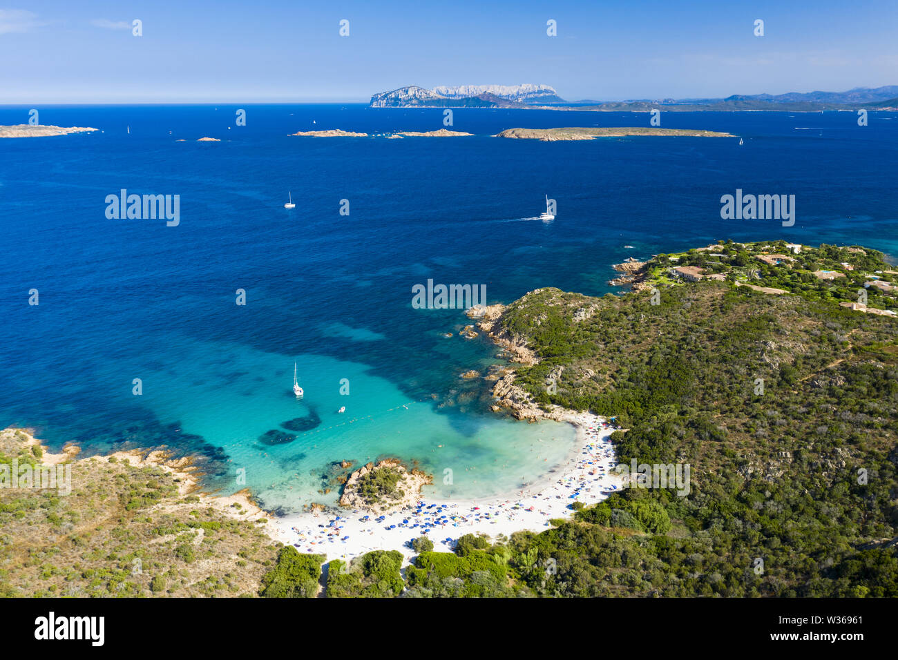 View from above, stunning aerial view of a beautiful beach bathed by a turquoise clear sea View from above, stunning aerial view of a beautiful beach bathed by a turquoise clear sea